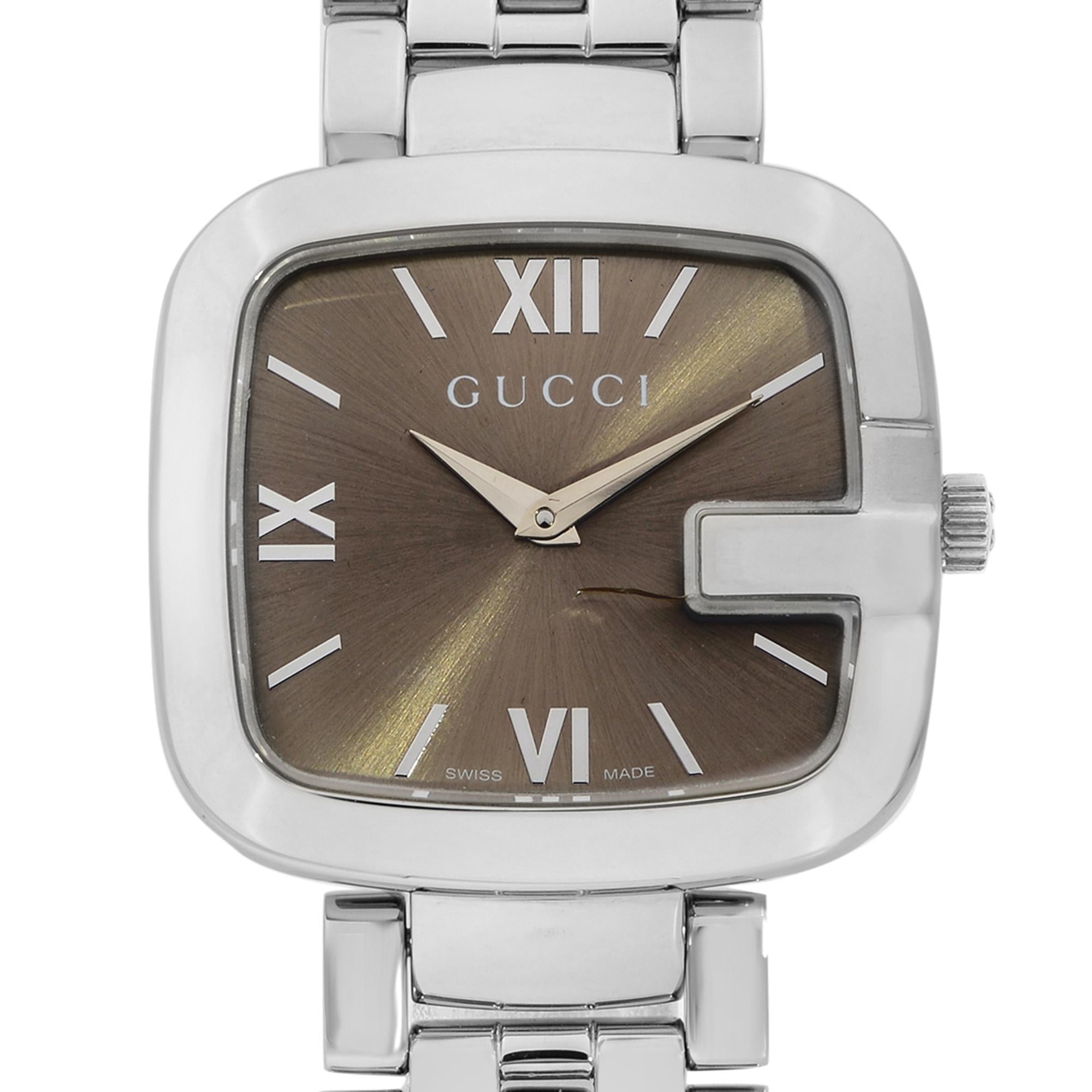 This pre-owned Gucci G-Gucci YA125410  is a beautiful Ladie's timepiece that is powered by quartz (battery) movement which is cased in a stainless steel case. It has a square shape face, no features dial and has hand sticks & numerals style markers.
