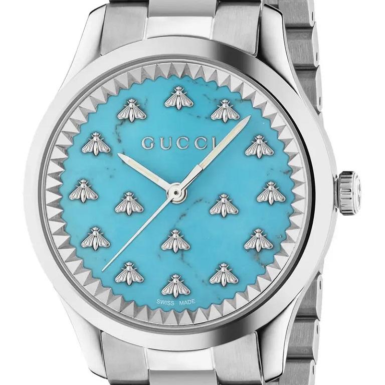 The G-Timeless collection continues to explore emblematic House codes in new ways each season. A turquoise stone dial defines this watch, framed by a silver-colored case and featuring the historical Gucci bee motif.

- 32mm steel case, turquoise