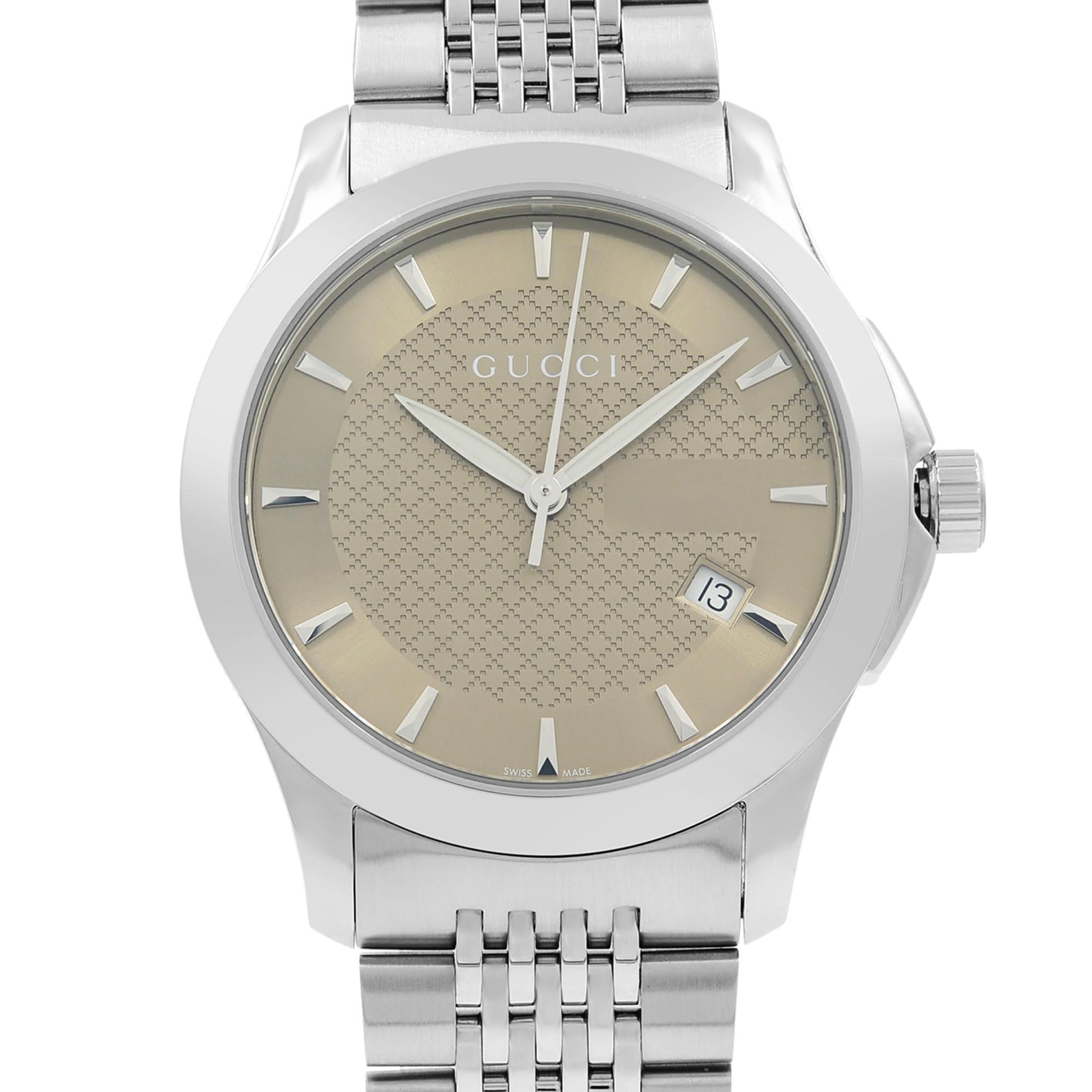 This display model Gucci G-Timeless YA126406 is a beautiful Ladies timepiece that is powered by a quartz movement which is cased in a stainless steel case. It has a round shape face, date dial and has hand sticks style markers. It is completed with