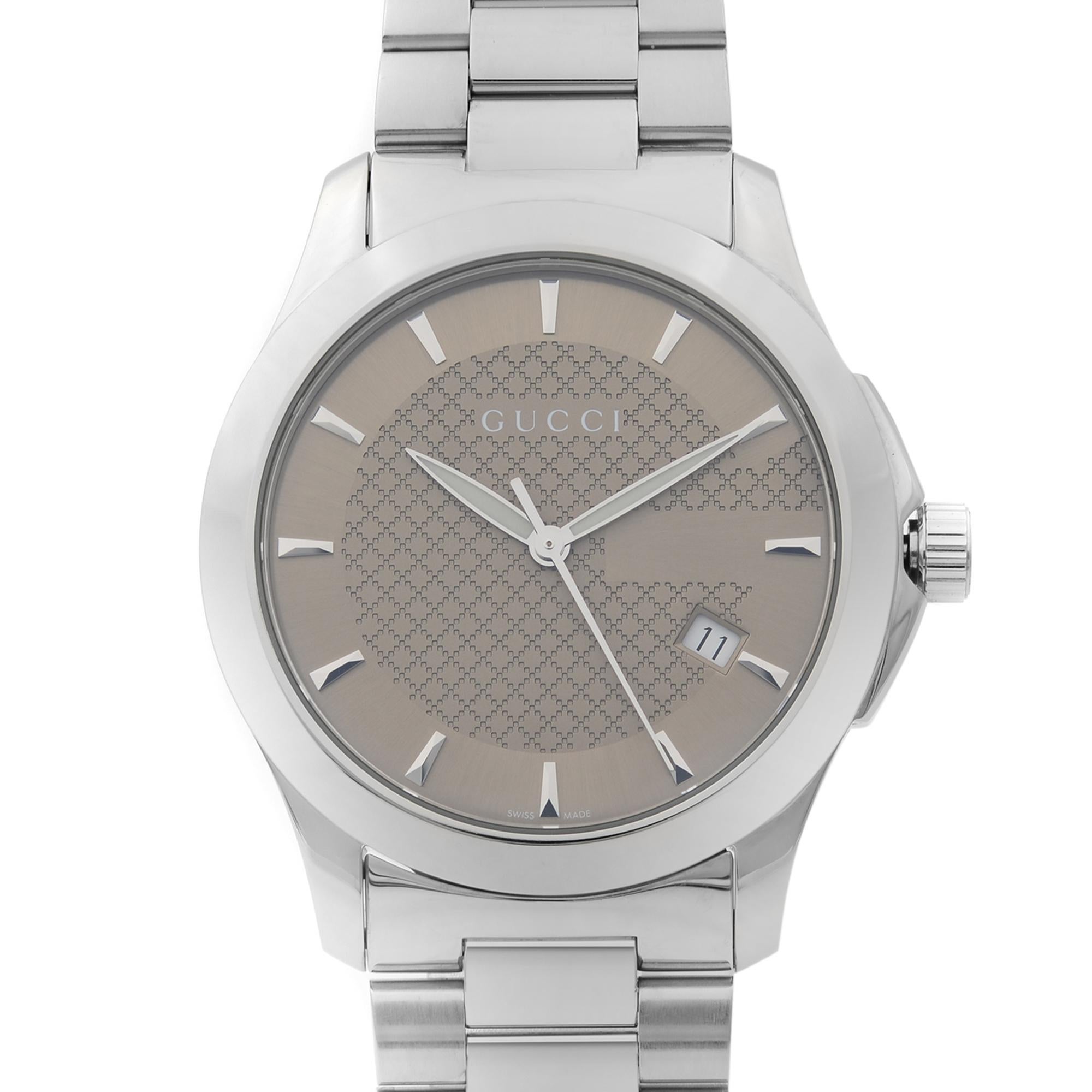This display model Gucci G-Timeless YA126406 is a beautiful men's timepiece that is powered by quartz (battery) movement which is cased in a stainless steel case. It has a round shape face, date indicator dial and has hand sticks style markers. Case