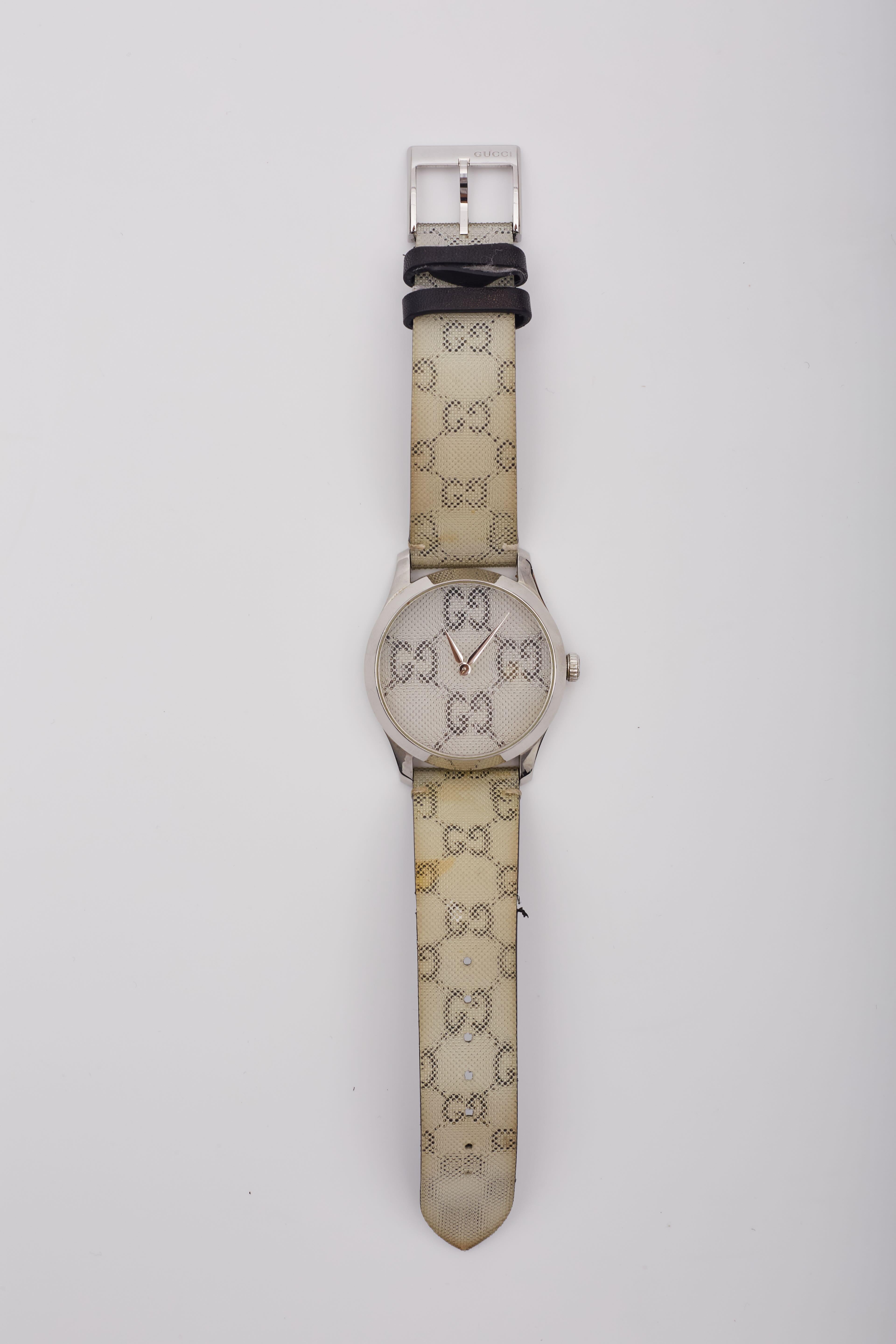 A GG logo floats holographically on the face and around the strap of a signature Swiss-made watch framed in polished stainless steel.

Color: Light silver
Code: 17358757
Comes with: Dust bag and box
Condition: fair. Marks, discoloration &