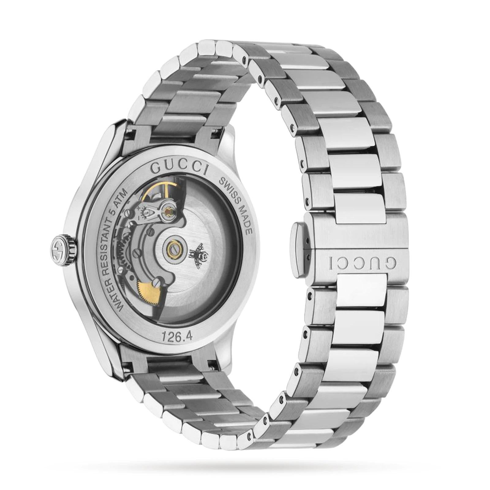 Part of the G-Timeless collection, this automatic watch is designed with a steel case and bracelet. The watch is characterized by the beautiful tiger eye stone dial, with each stone having a unique veining and color. At the center are bees, a