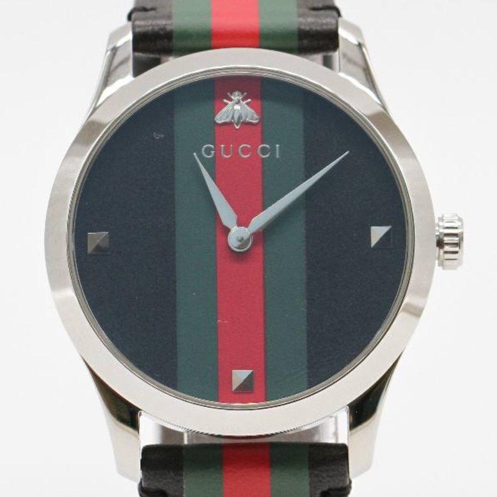 GUCCI G-TIMELESS Watch YA1264079 Brand New Watch, 38mm stainless steel case excluding crown. Case thickness 8mm. Sapphire crystal. Green and red woven dial with bee emblem. Leather strap. Strap width 20mm. Quartz movement. Water resistant 5atm.