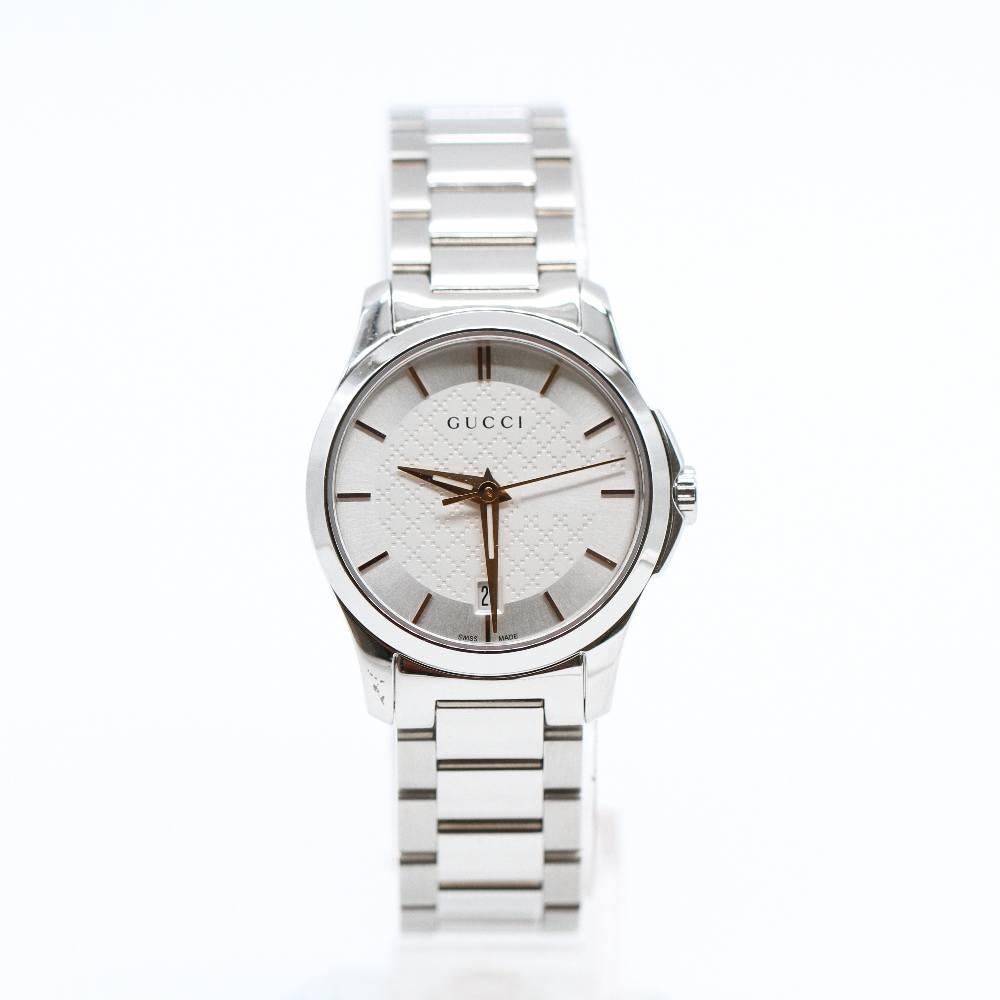 GUCCI LADIES G-TIMELESS Watch YA126523 Brand New Watch, steel case 27mm excluding crown. Case thickness 6.8mm. Sapphire crystal. Silver dial with diamond shaped design. Stainless steel bangle, 14mm wide. Folding clasp. Quartz movement. Water