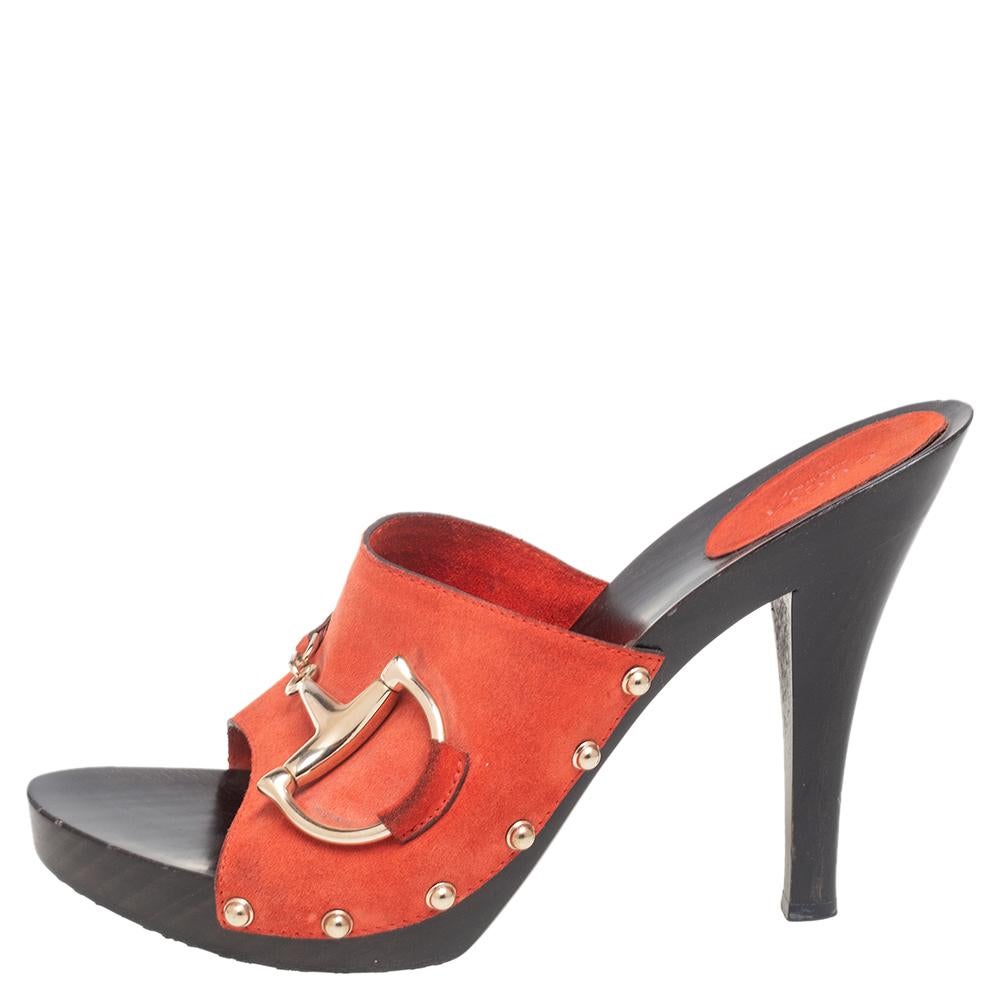 These sandals by Gucci are perfect to be paired with any outfit of your choice. The suede sandals are meant to keep your feet comfortable all day. Designed as clogs, the red sandals are lifted on platforms and 10.5 cm heels.