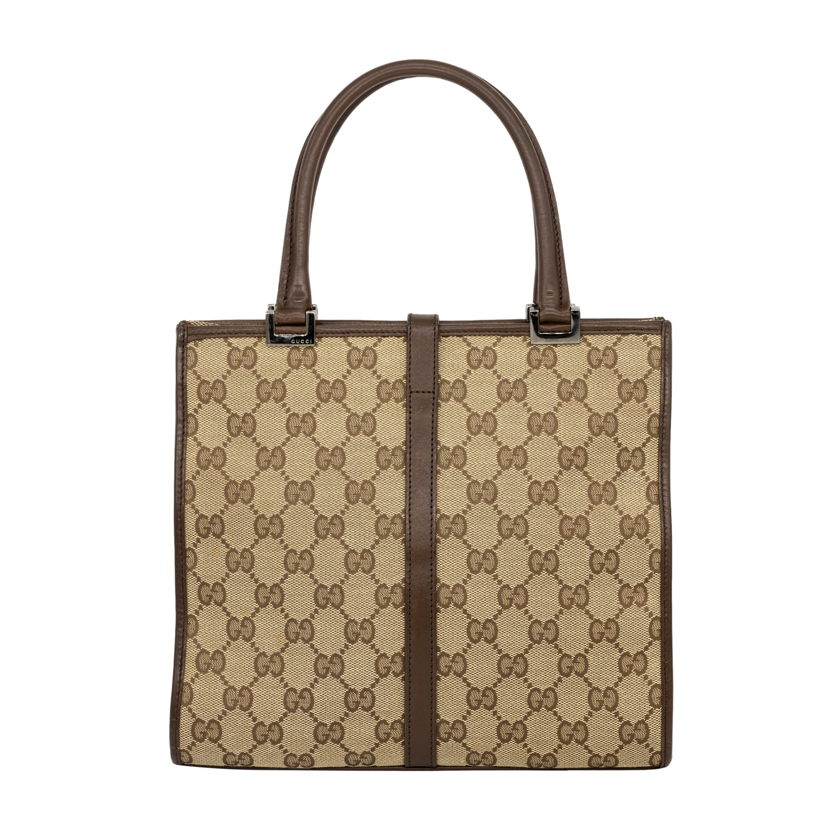 Gucci GG Brown Monogram Small Jackie Line Top Handle Tote Bag, 2000. The classic half moon shaped bag was made by the iconic fashion house in the 1950's and was coined the 