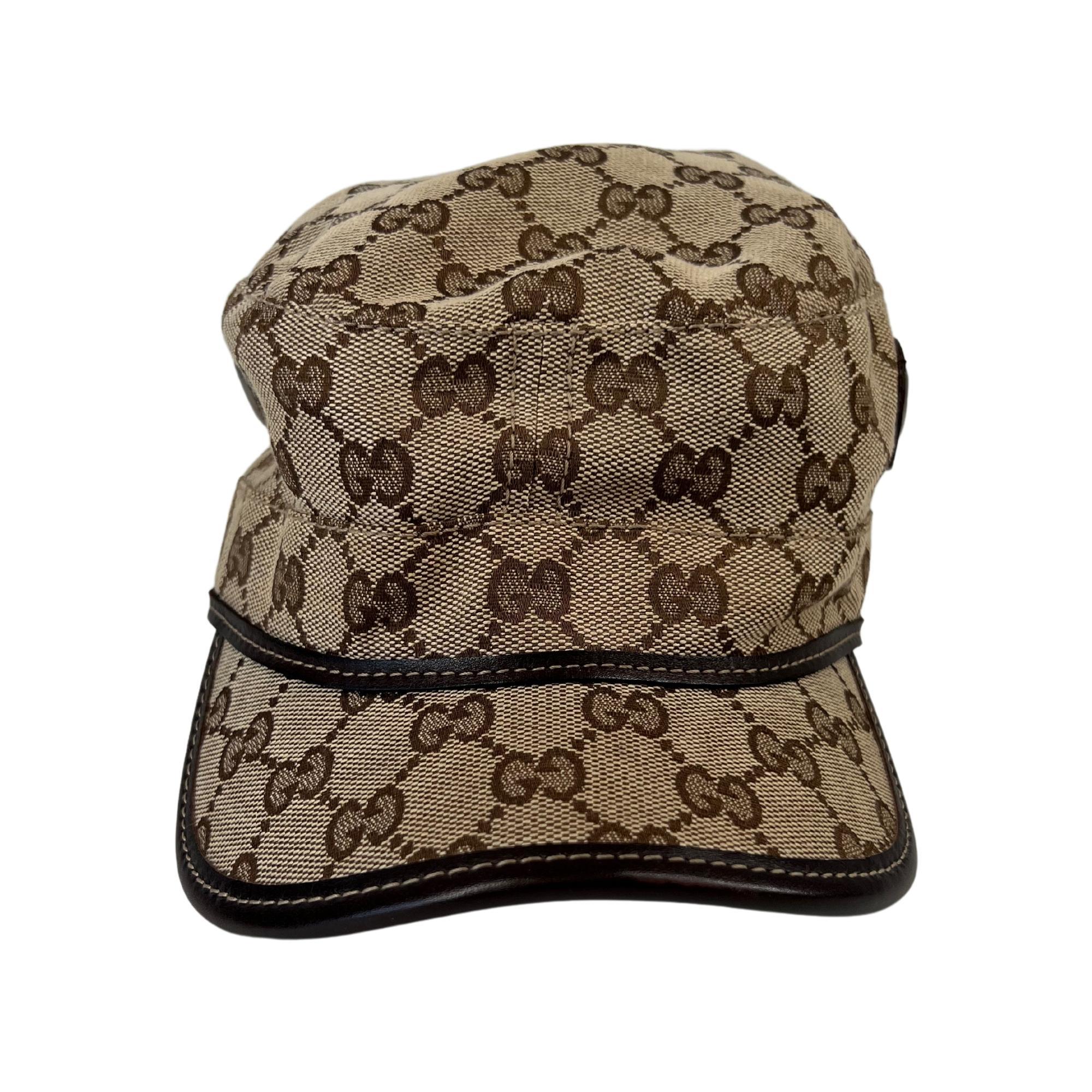 This hat features Gucci GG canvas in beige, leather trim, metal grommet detail, adjustable leather strap and buckle closure.

COLOR: Brown
MATERIAL: Cotton 32% and polyester 63%
ITEM CODE: 200037 FCEKN
SIZE: Small
CONDITION: Very good - lightly used