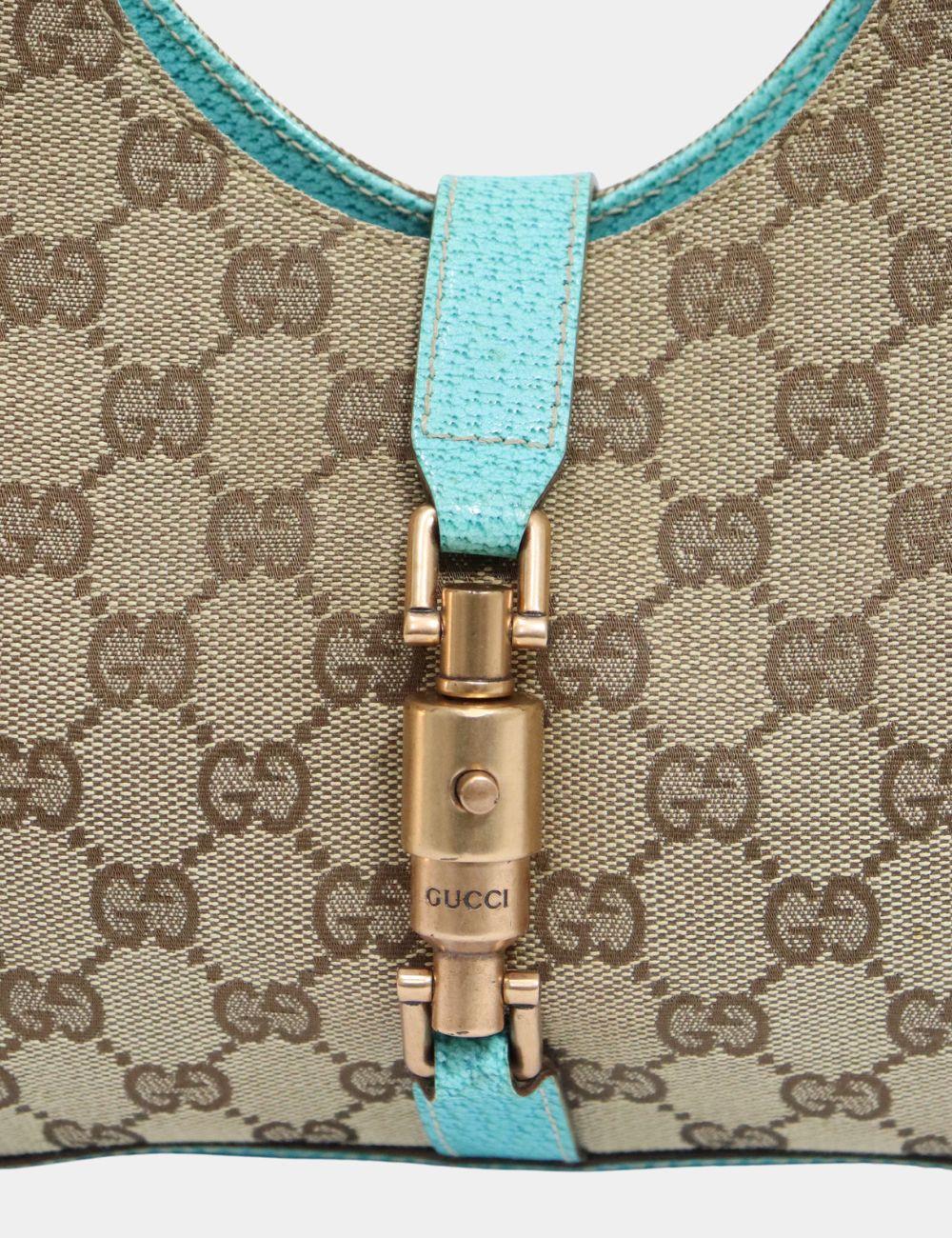 Gucci GG Canvas Jackie O Hobo, Features two leather handles for shoulder, GG canvas, and  one interior pocket.

Material: Leather
Hardware: Gold
Height: 15cm
Width: 26.5cm
Depth: 5cm
Handle Drop: 22cm
Overall condition: Fair
Interior condition:
