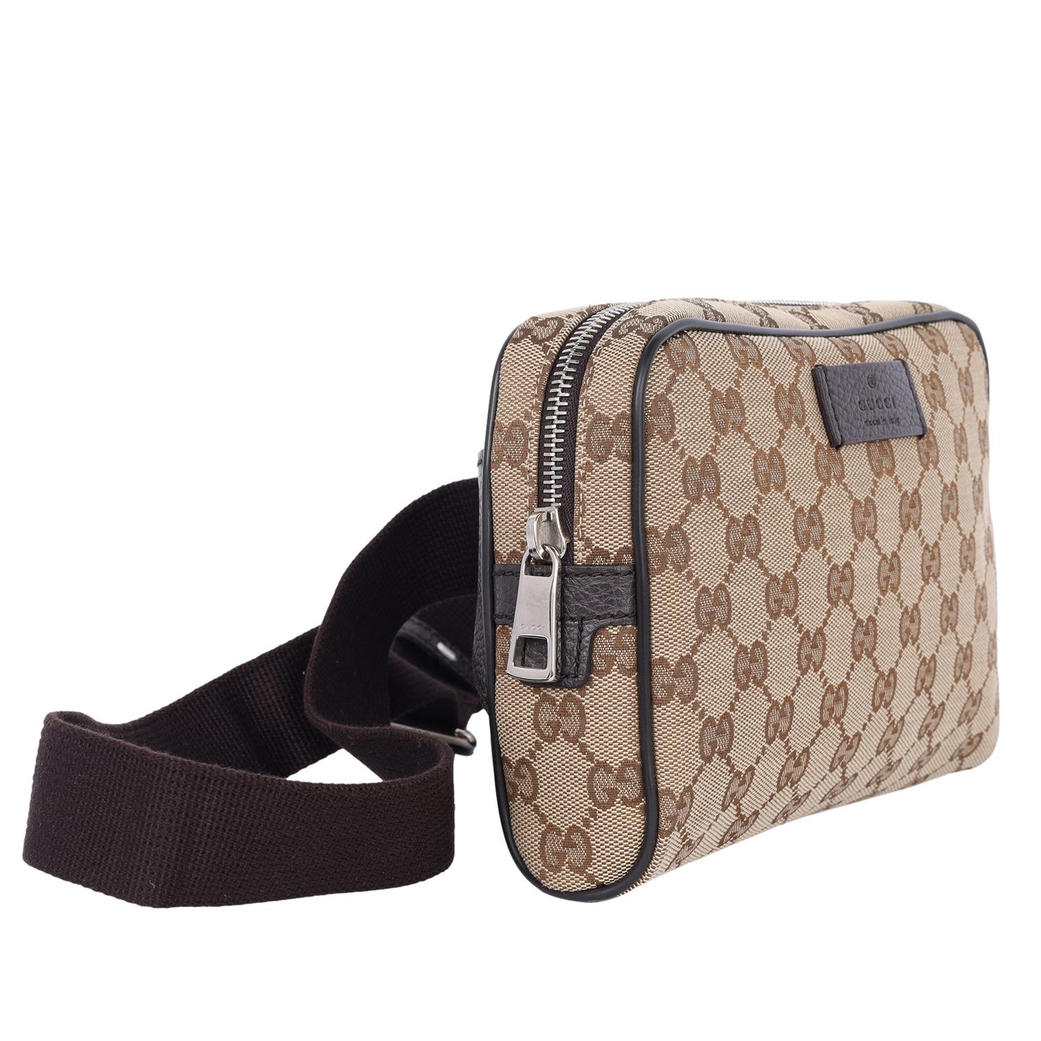 Authentic, pre-owned Gucci GG canvas belt bag in brown monogram. Features brown canvas and leather exterior accents, zipper closure, buckle belt, silver hardware, large interior with slip pocket. Your going to love that this bag fits your phone and