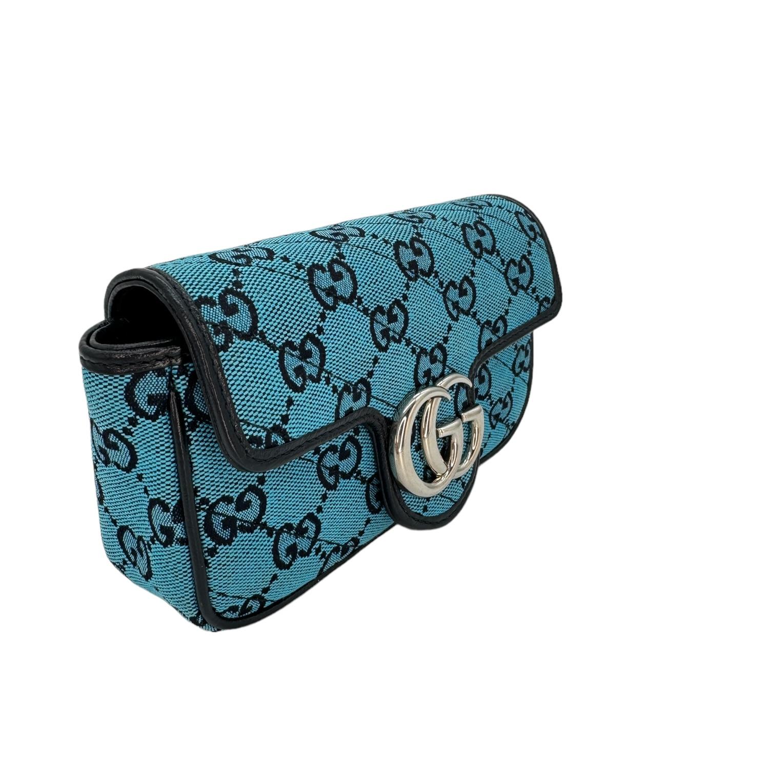 This shoulder bag is crafted of GG monogram canvas in blue. This bag features a polished silver chain shoulder strap and a front flap that features an interlocking GG logo. The flap opens to a beige fabric interior and includes a removable key