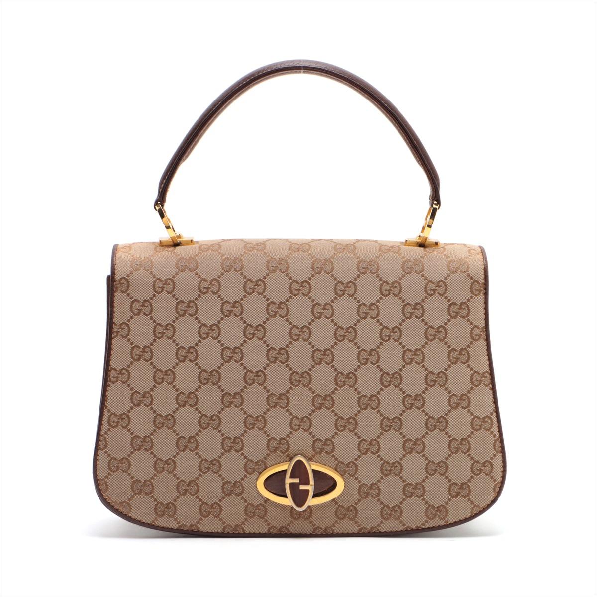 The Gucci GG Canvas Top Handle Bag in Beige is a timeless and sophisticated accessory, epitomizing the brand's signature style. Crafted from the iconic GG canvas, the bag features Gucci's classic monogram print in a versatile beige hue, exuding