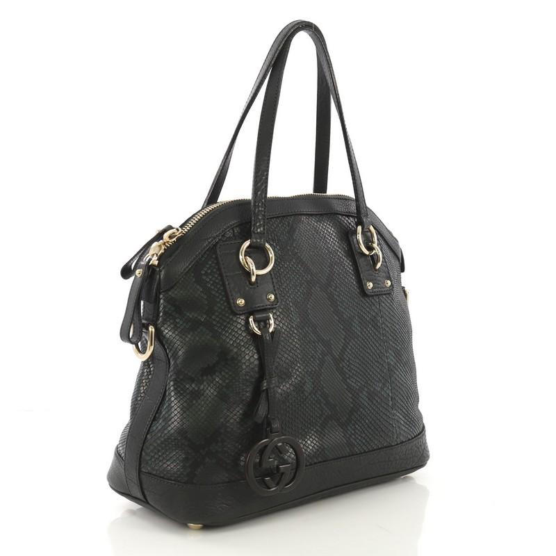 This Gucci GG Charm Convertible Dome Satchel Python Large, crafted from genuine dark green python and leather, features dual flat leather handles and gold-tone hardware. Its two-way zip closure opens to a brown microfiber interior with zip and slip
