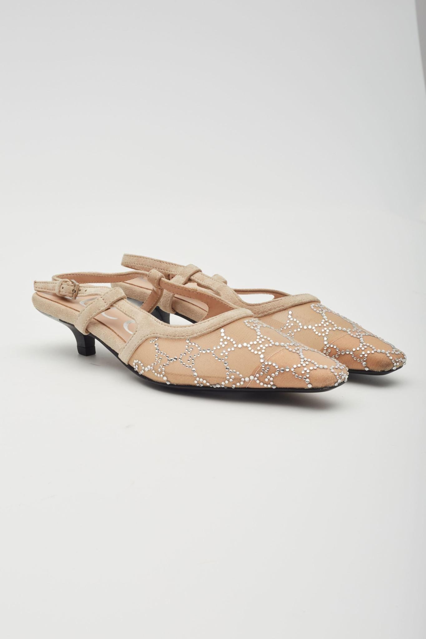 The pumps are part of Gucci’s Aria collection and feature beige mesh construction with GG crystal embellishments, tonal suede details, pointed square toe, a leather sole, back buckle closure and a low heel 1.5 inch (38 mm) heel. Outlet.

Color: