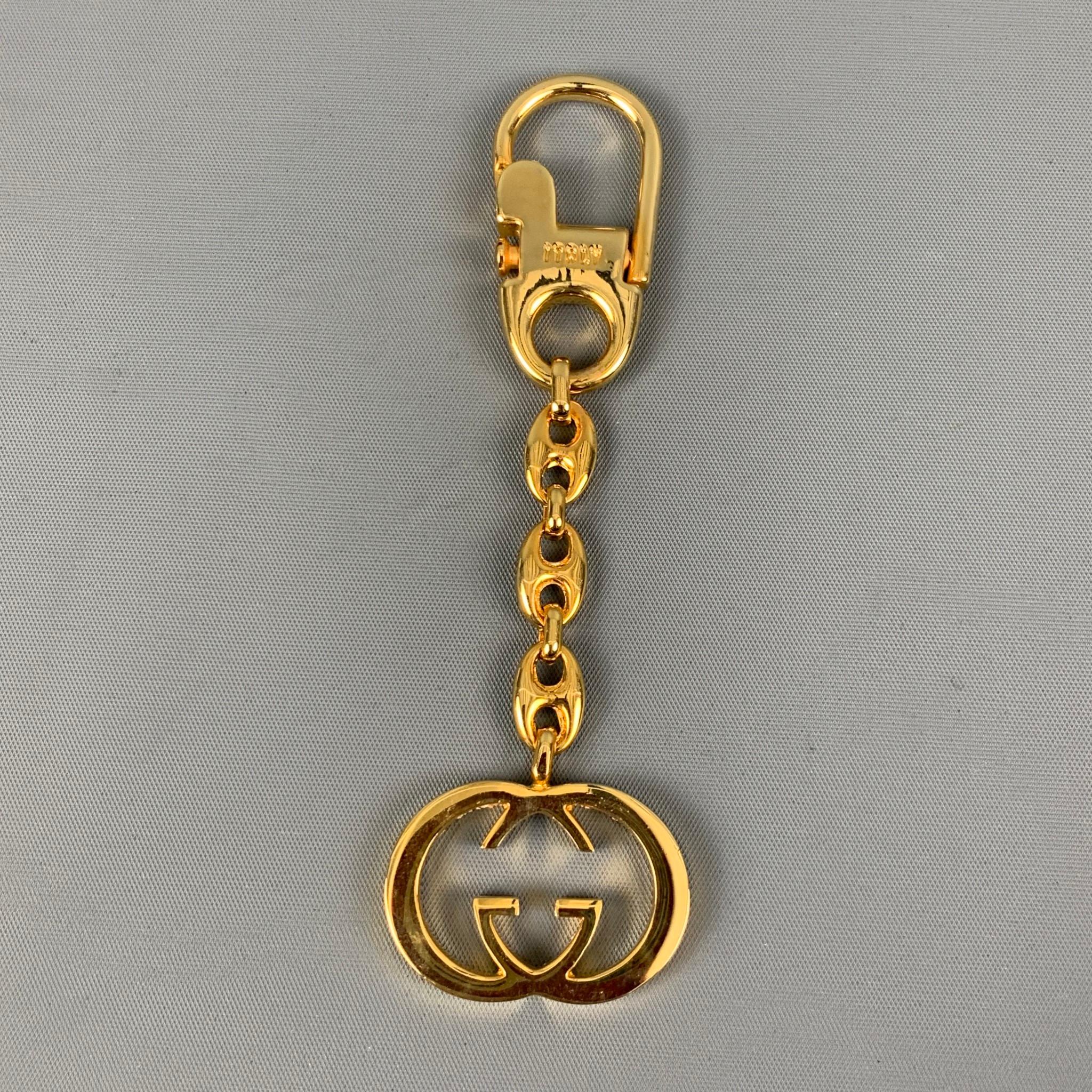 Vintage GUCCI interlocking GG key chain comes in a gold metal material. Comes with the Box.

Very Good Pre-Owned Condition.

Measurements:

Length: 5 in. 

SKU: 124428
Category: Bags & Leather Goods

More Details
Brand: GUCCI
Color: Gold
Pattern: