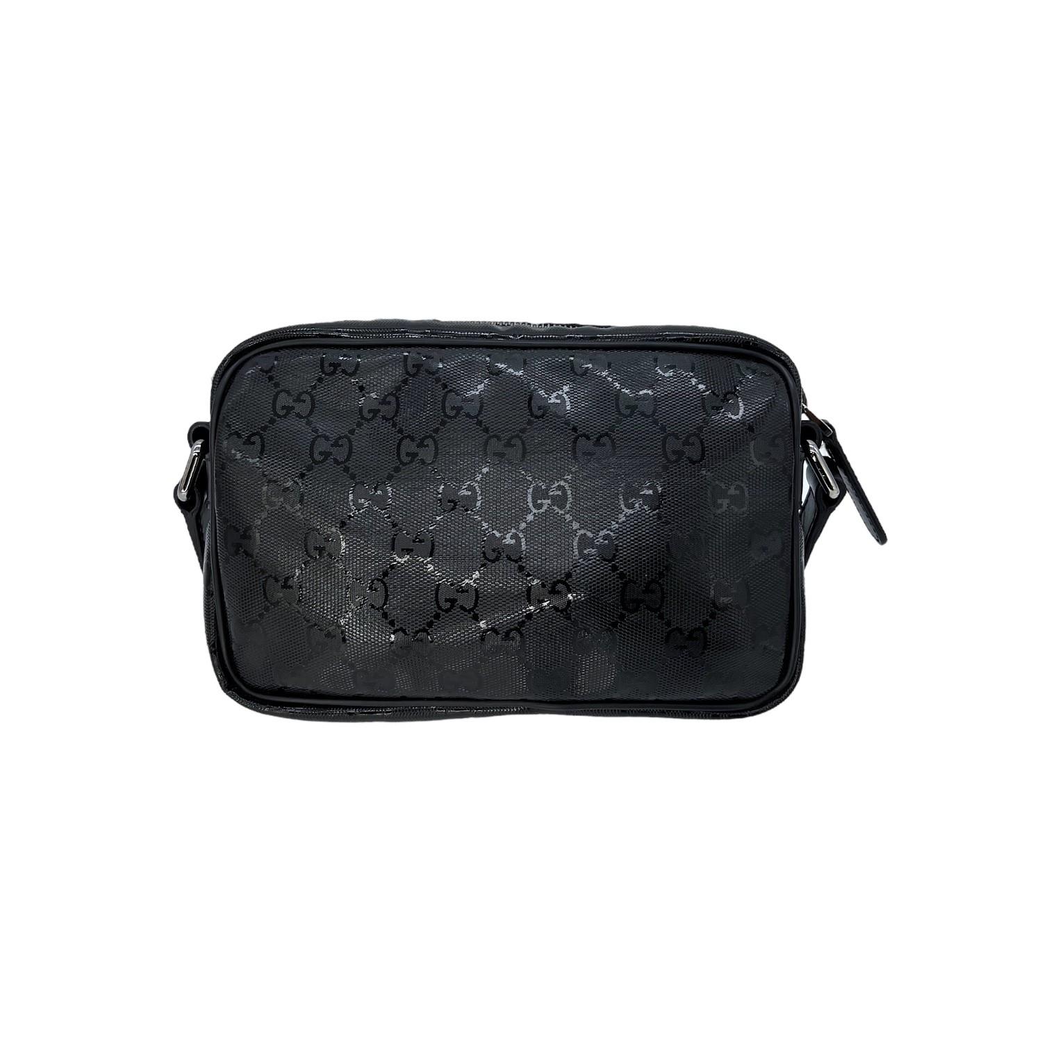 This Gucci GG Imprime Camera Bag was made in Italy and it is finely crafted of a black Gucci GG PVC exterior with leather trimming and silver-tone hardware features. It has a flat leather adjustable shoulder strap. It has a zipper pocket on the