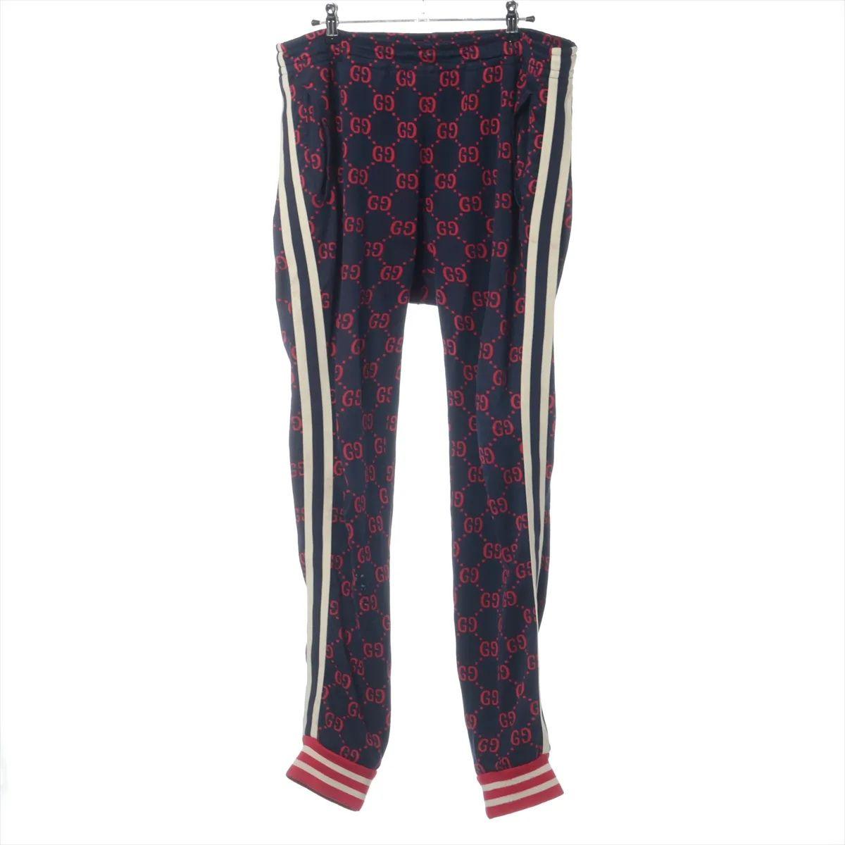 The Gucci GG Jacquard Cotton Track Pants in Navy Blue and Red are a luxurious take on classic sportswear. Crafted from soft cotton jacquard, these feature the iconic interlocking GG pattern woven throughout in a contrasting red tone against the deep