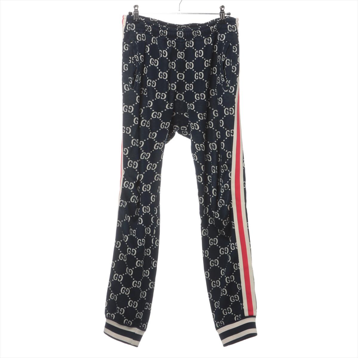 The Gucci GG Jacquard Jogging Pant in Navy Blue combines luxury with athletic-inspired design. The pants feature an iconic GG jacquard pattern throughout, showcasing Gucci's signature style. Adorned with white and red stripes on both sides and white