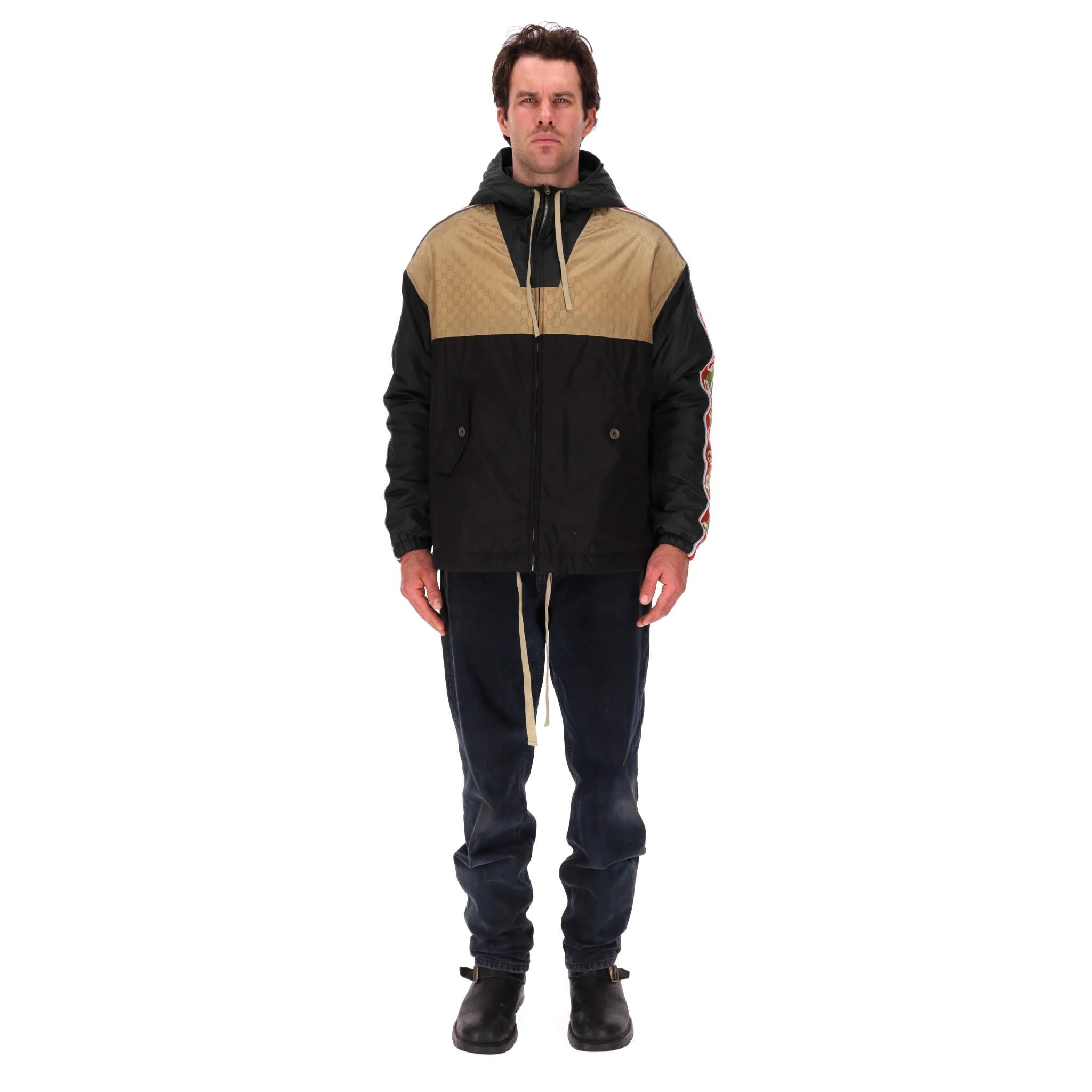 Gucci GG Jacquard Logo & Web Stripe Nylon Jacket

Beige GG jacquard top with black base and hood.

Detailed with signature interlocking G Web stripe down the green sleeves with reflective fabric piping.

Front flap pockets with button closure,