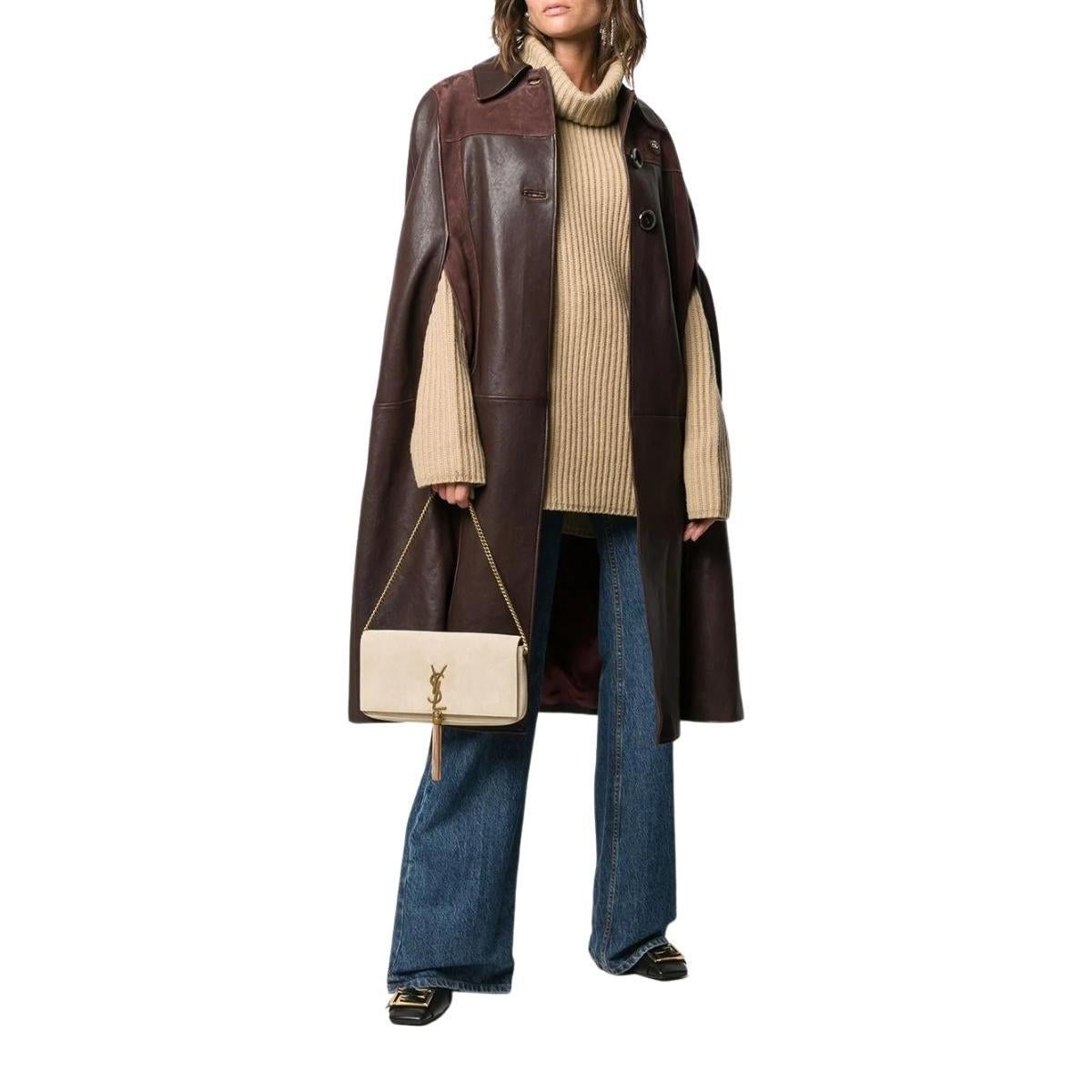 Chocolate-brown cape
Grained leather
Suede panels
Gold GG plaque. 
Classic collar
Front button fastening
Armholes
Burgundy logo-jacquard lining.
Composition: Lamb Skin 100%
Lining: Viscose 100%
Designer Style ID: 624144XNALD
Made in Italy