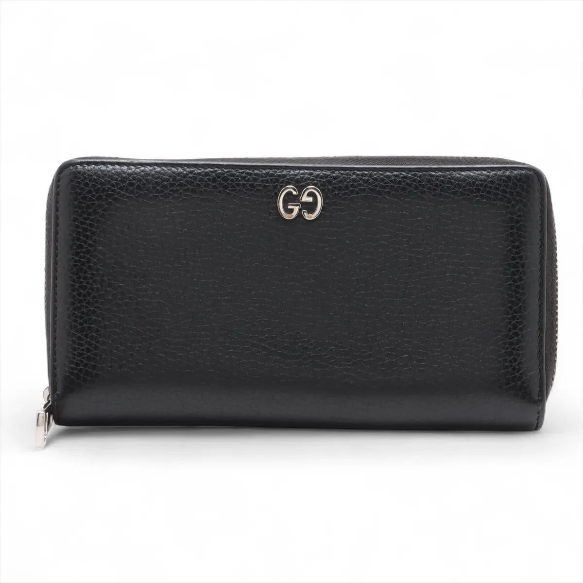 The Gucci GG Logo Leather Zip Round Wallet in Black is a sleek and timeless accessory crafted from smooth leather with the iconic GG logo detail on the front. Designed for both style and functionality, it features a secure zip-around closure that