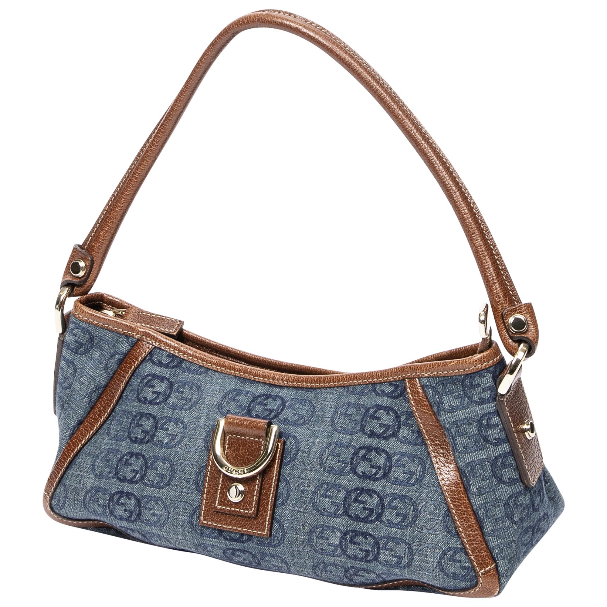 Channel effortless cool with the Denim Dreamer Crossbody. Crafted from versatile blue denim, it's accented with shimmering gold hardware for a touch of glam. Featuring a secure zipper closure, it opens to a durable fabric interior, perfect for your
