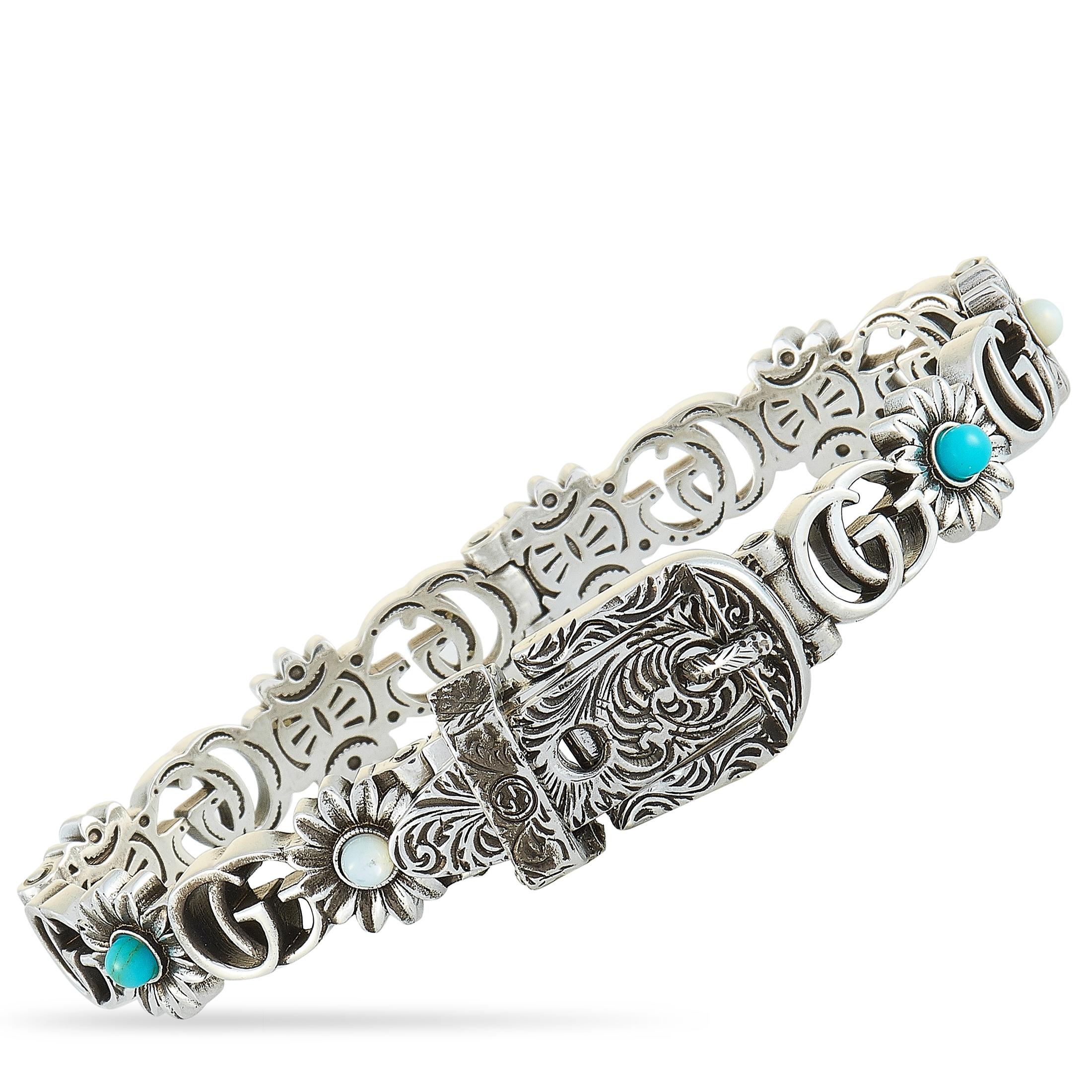 The Gucci “GG Marmont” bracelet is crafted from aged sterling silver and decorated with turquoise resin, topaz, and mother of pearl. The bracelet weighs 33 grams and measures 6.50” in length.
 
 This item is offered in brand new condition and