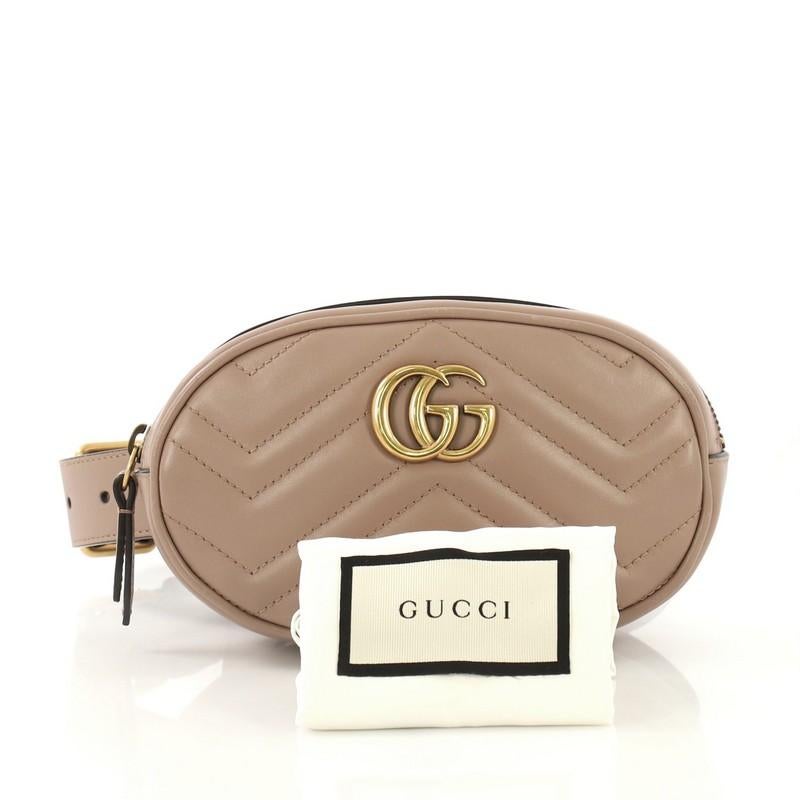This Gucci GG Marmont Belt Bag Matelasse Leather, crafted in brown matelasse leather, features an adjustable belt strap, GG logo at front and aged gold-tone hardware. Its zip closure opens to a light pink microfiber interior with slip pocket.
