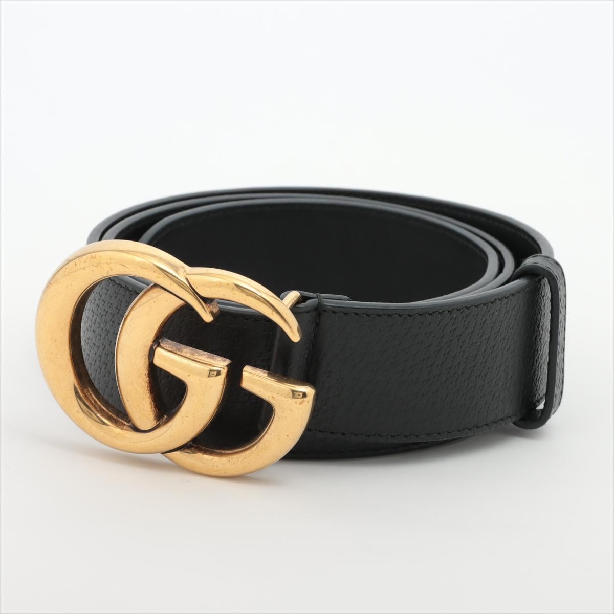The Gucci GG Marmont Belt in Black is a sleek and sophisticated accessory that effortlessly combines style and versatility. Crafted from smooth leather, the belt features an iconic GG Marmont logo buckle in an antique gold-tone finish, adding a