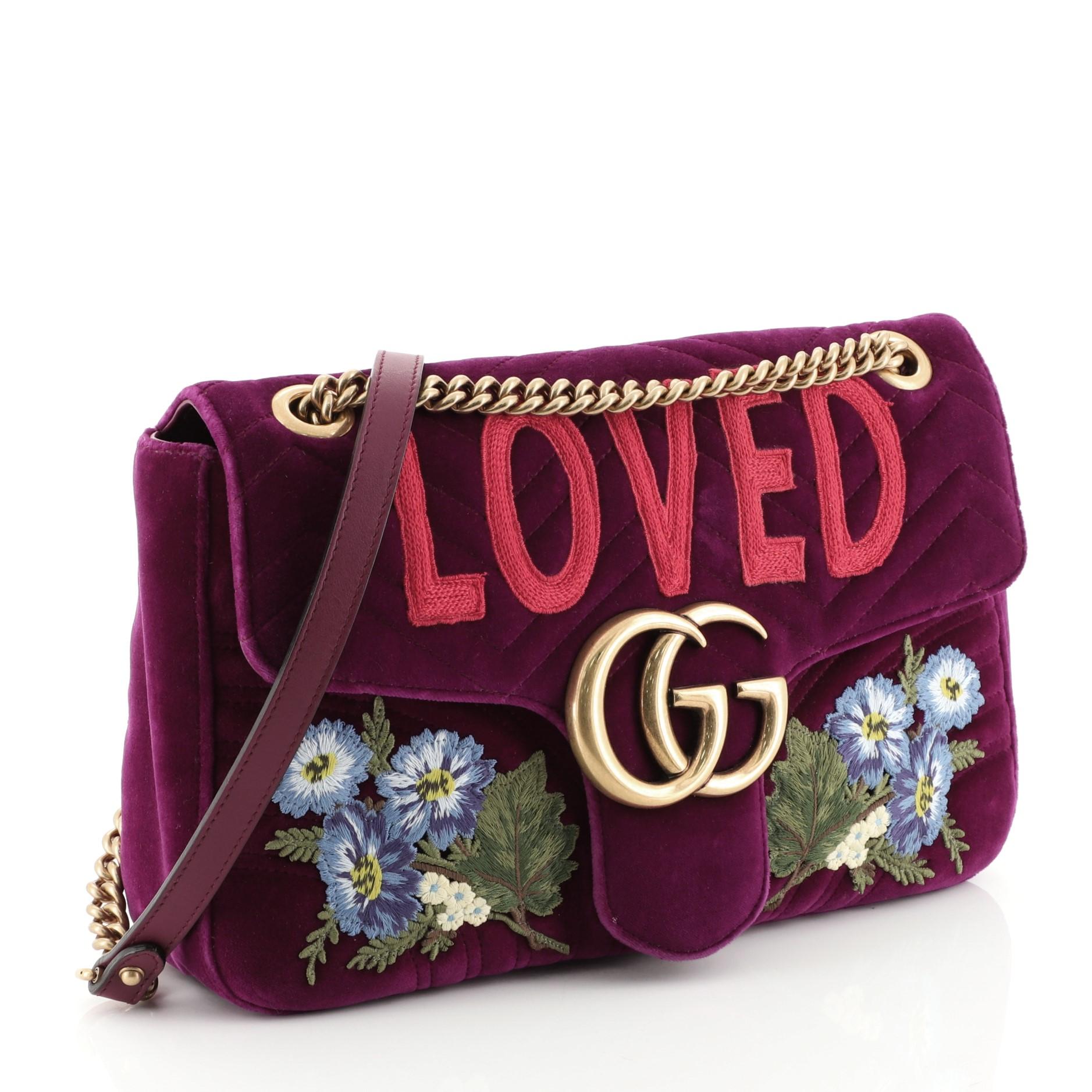 This Gucci GG Marmont Flap Bag Embroidered Matelasse Velvet Medium, crafted in purple embroidered matelasse velvet, features chain link shoulder strap with leather pad, embroidered flowers, GG logo at front flap and aged gold-tone hardware. Its