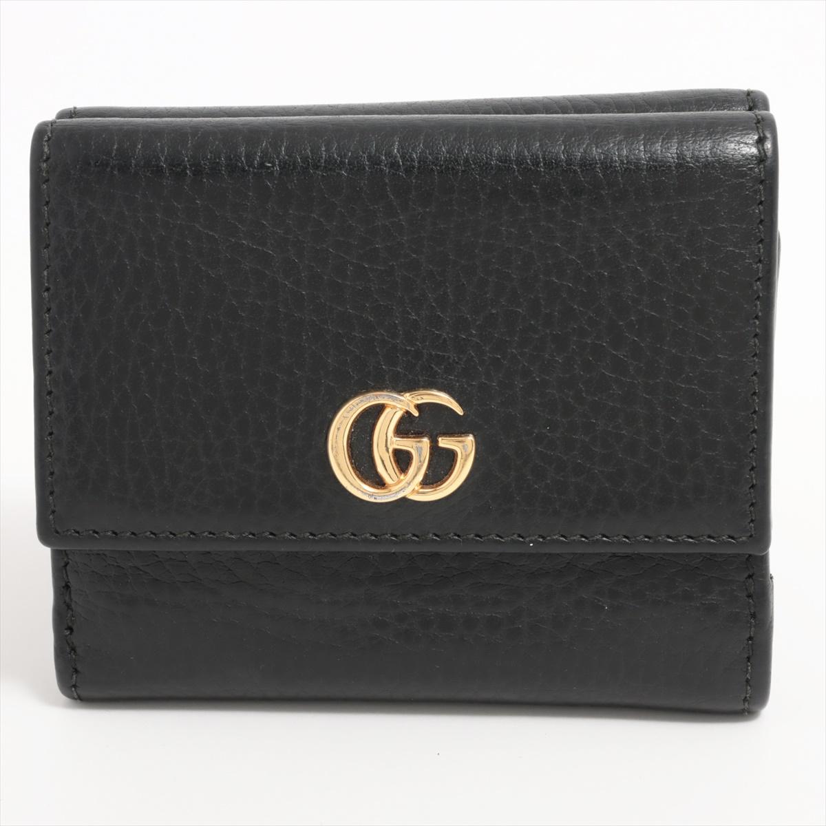 The Gucci GG Marmont Leather Compact Wallet in Black is a chic and practical accessory that seamlessly combines style with functionality. Crafted from high-quality black leather, the wallet features iconic GG logo, reflecting Gucci's signature