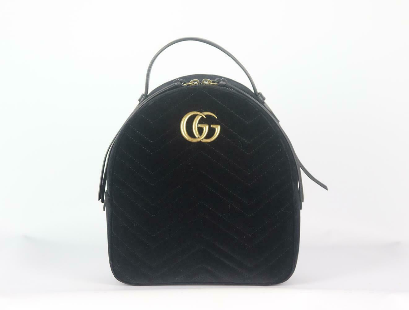 This backpack has been made in Italy from plush velvet and decorated with the iconic lettered plaque, the chain and leather shoulder straps provide support which opens to reveal a pink satin interior inspired by vintage accessories. 
Black velvet