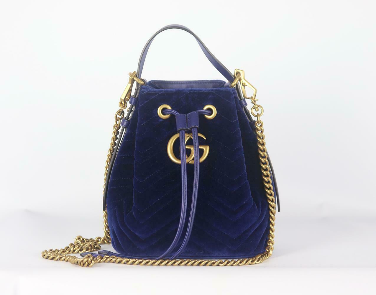 This bucket bag has been made in Italy from plush velvet and decorated with the iconic lettered plaque, the drawstring fastening opens to reveal a pink satin interior inspired by vintage accessories. 
Blue velvet and leather (Calf). 
Drawstring