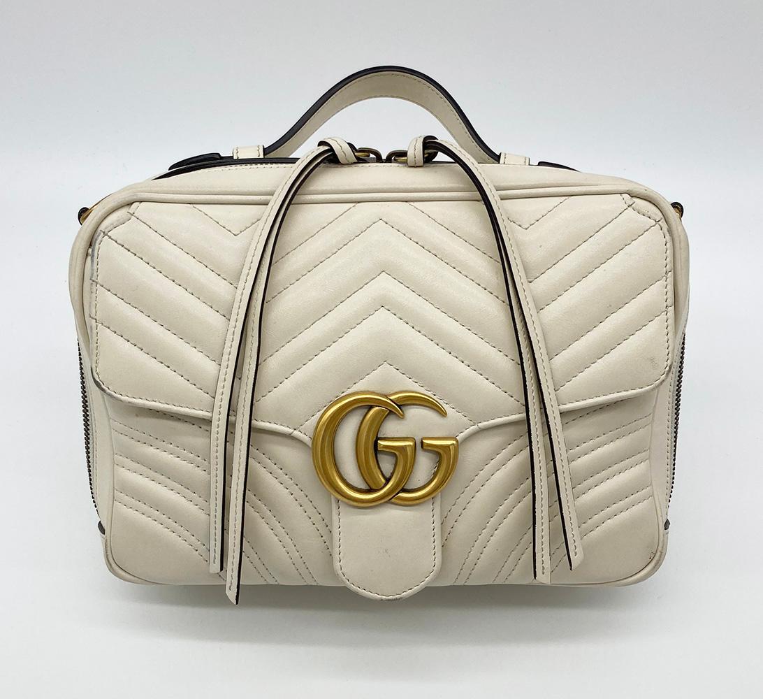 Gucci GG Marmont Matelasse Top Handle Flap Bag in fair condition. Cream matelasse chevron quilted leather exterior trimmed with antiqued brass hardware and removable blue red and white striped canvas shoulder strap. Front flap pocket with GG