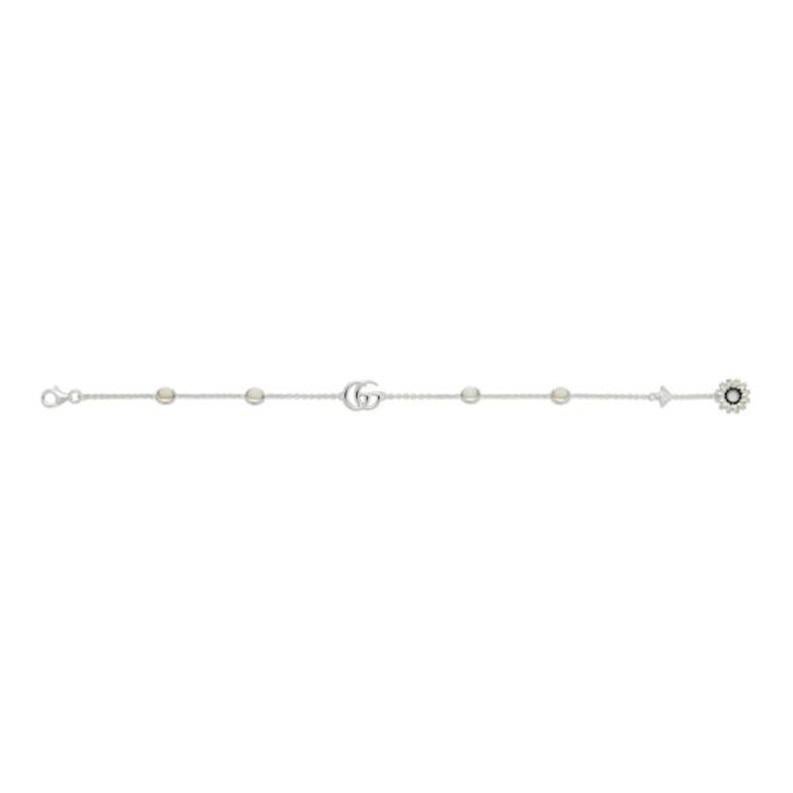 From Gucci, the GG Marmont fashion jewelry pieces blend crystals, pearl accents and Double G details as a charm or along the metal chain across a full collection of pieces. This delicate bracelet is presented in sterling silver and enriched by a