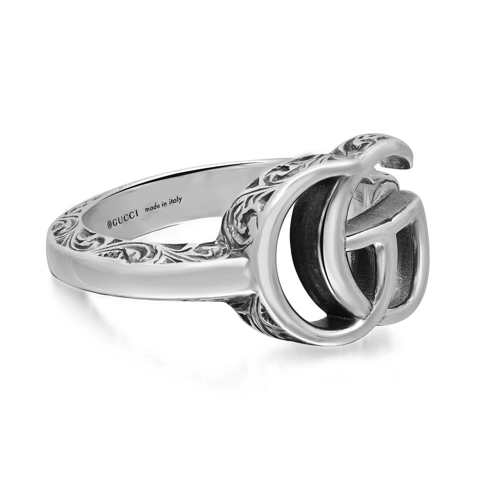 Gucci GG Marmont open key ring featuring a Double G symbol that sits atop a key which is formed into a ring. Crafted in 925 sterling silver with an aged finish and engraved edges. Ring size 7. Band width: 3.4 mm. Double G size: 11mm x 13mm. Total