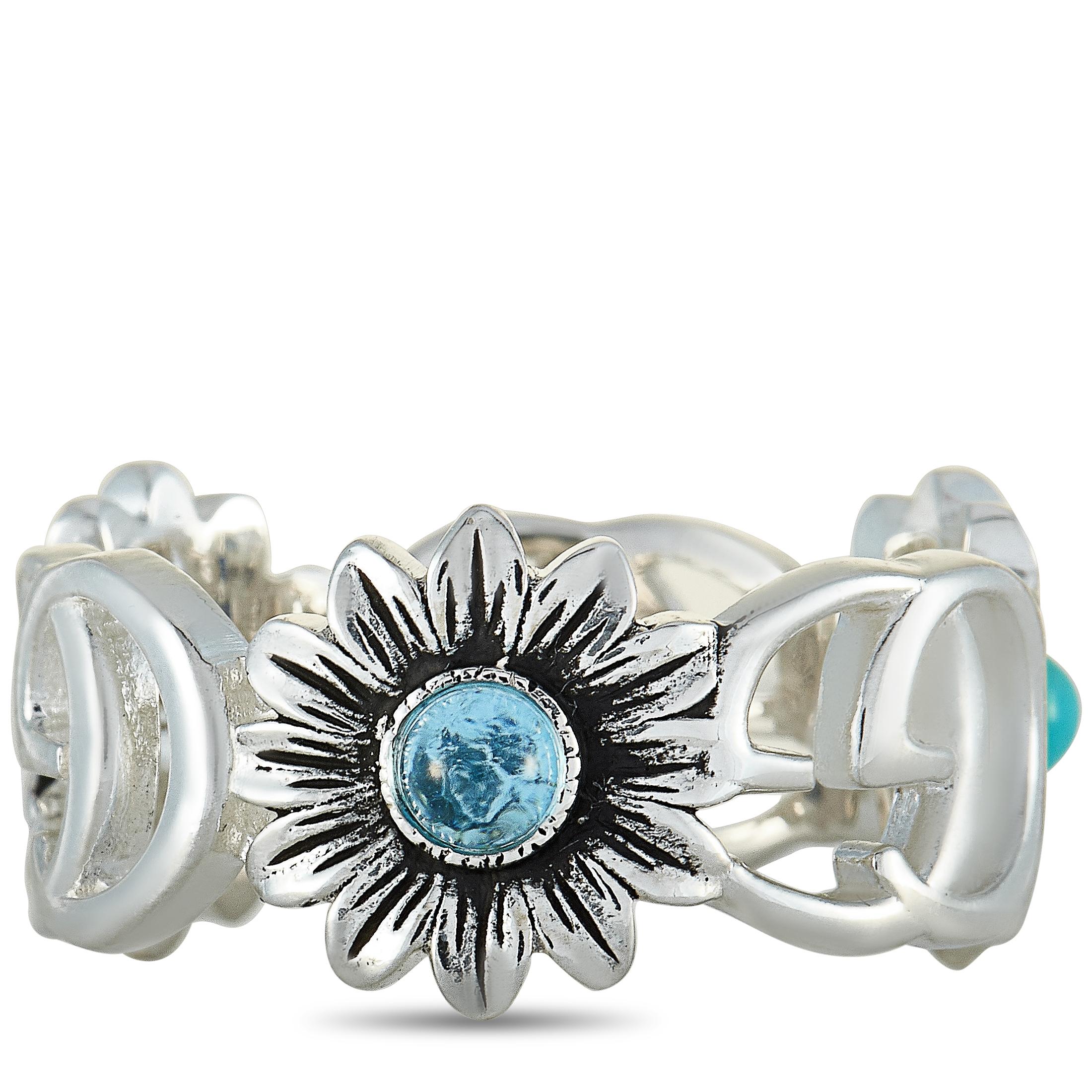 The Gucci “GG Marmont” ring is crafted from sterling silver and set with a blue topaz, and turquoise and mother of pearl resin. The ring weighs 4.4 grams and boasts band thickness of 7 mm.
 
 This jewelry piece is offered in brand new condition