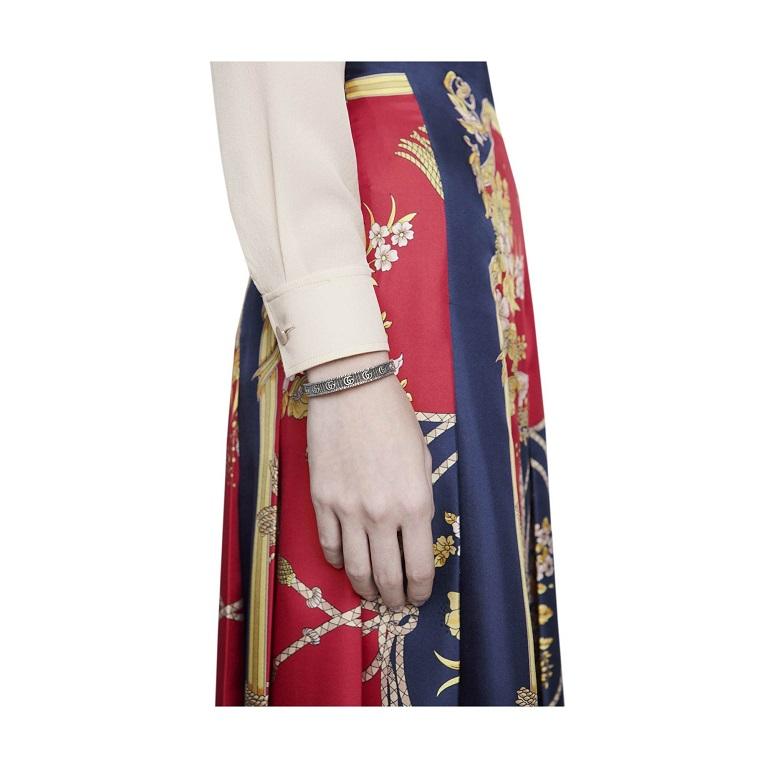 Gucci Unisex Bracelets. SKU: YBA551903001. Gucci Double G Motif Open Bangle. This bangle is set against a three-dimensional striped design with a antique finishes and boasts the iconic double G.

The iconic double G continues to define house