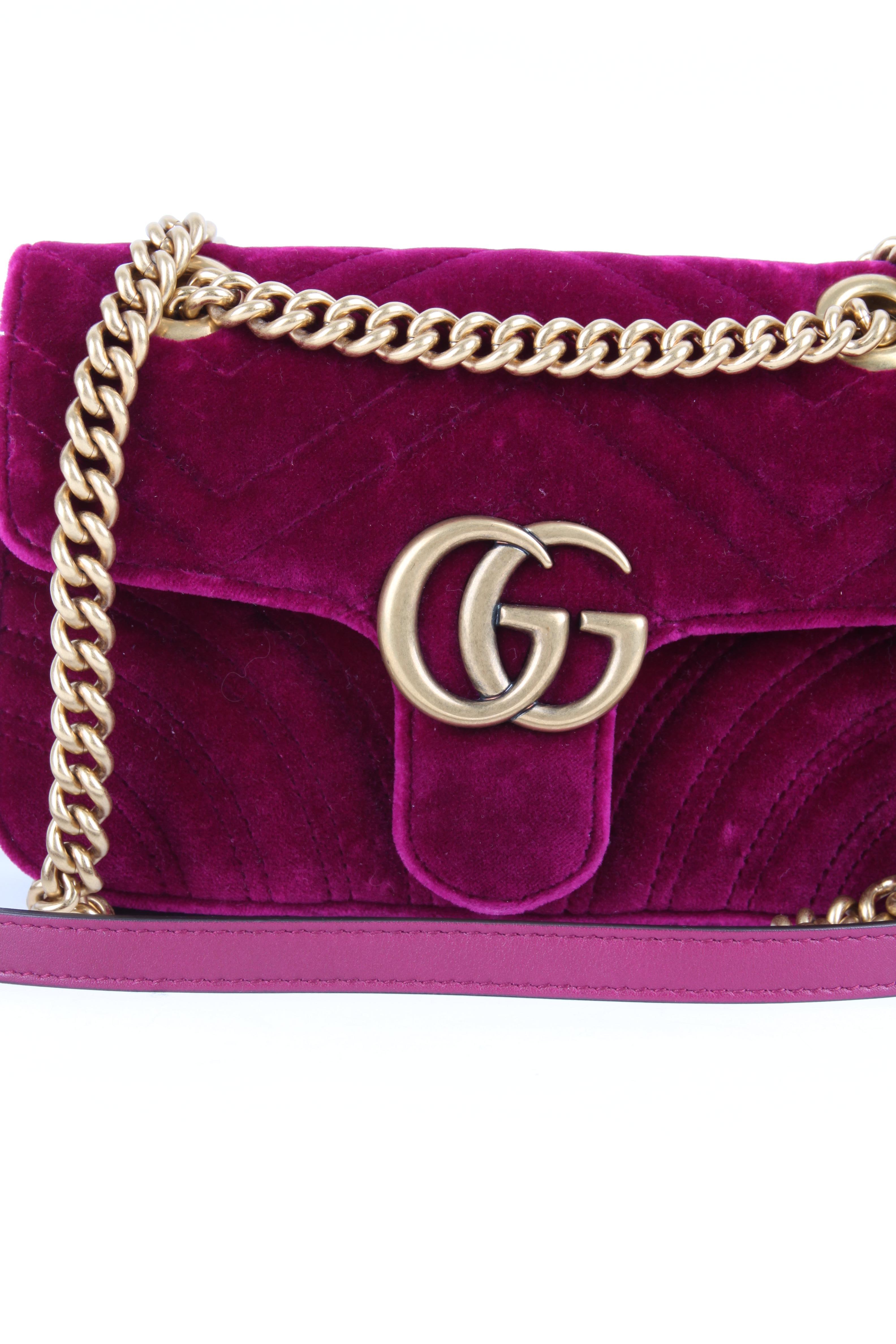 
This popular Gucci GG Velvet Marmont shoulder bag is made in Italy.

The leather has been quilted in different patterns, on the back you even find a heart. Front closure, a large GG logo on top of it. Hardware in gunmetal gold. The shoulder strap