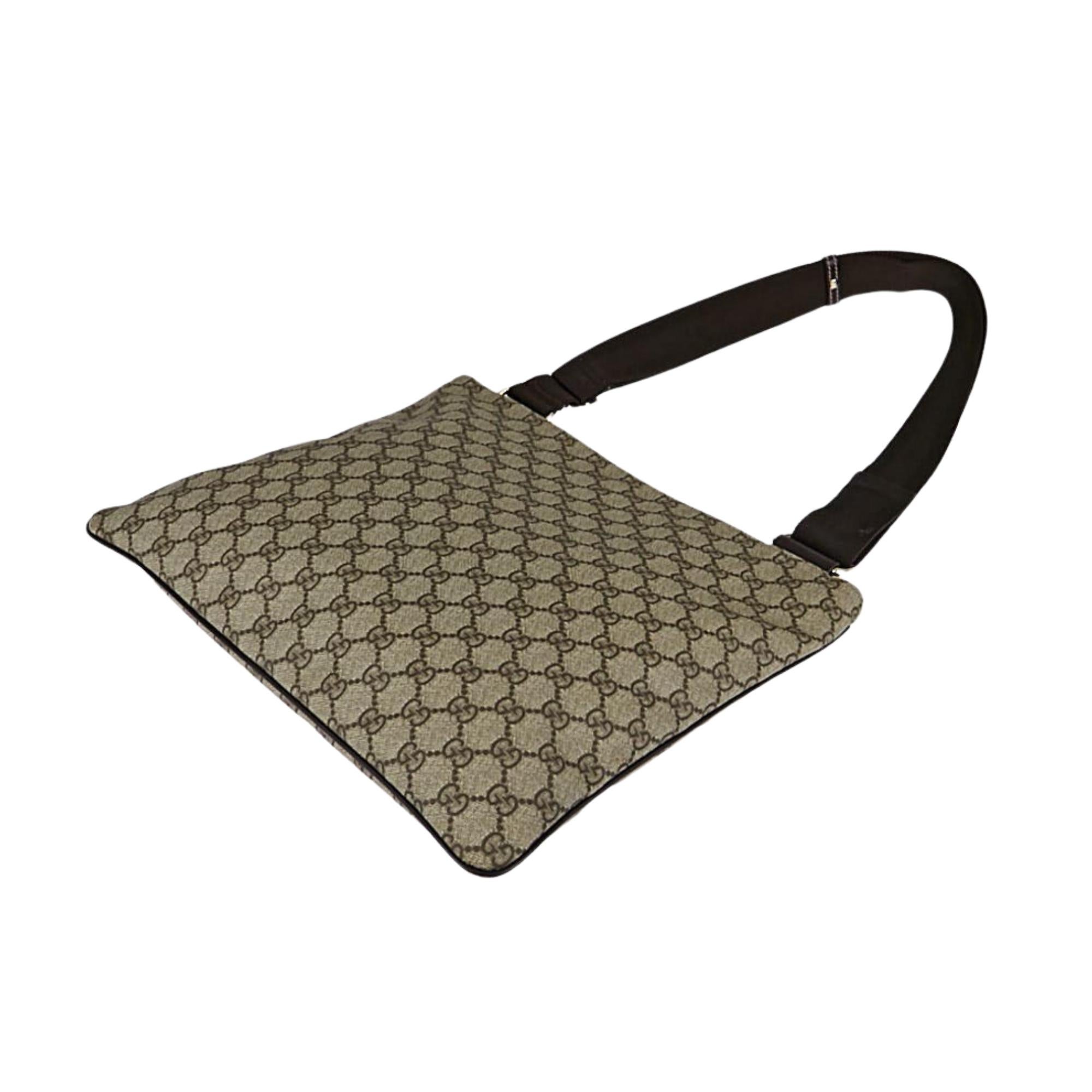 This Gucci beige/ebony monogram crossbody bag is made with GG supreme coated canvas with leather finishes and a woven fabric shoulder strap. The bag features zip closure and a light cream coloured woven fabric interior with a slip pocket for your