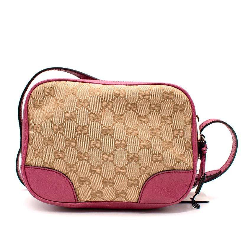 Gucci GG Monogram Canvas & Pink Leather Camera Bag
 
 
 
 - Monogram canvas body trimmed with pink grained leather
 
 - Zip top
 
 - Adjustable shoulder strap 
 
 
 
 Materials 
 
 100% Canvas 
 
 100% Leather 
 
 
 
 Made in Italy 
 
 
 
 PLEASE