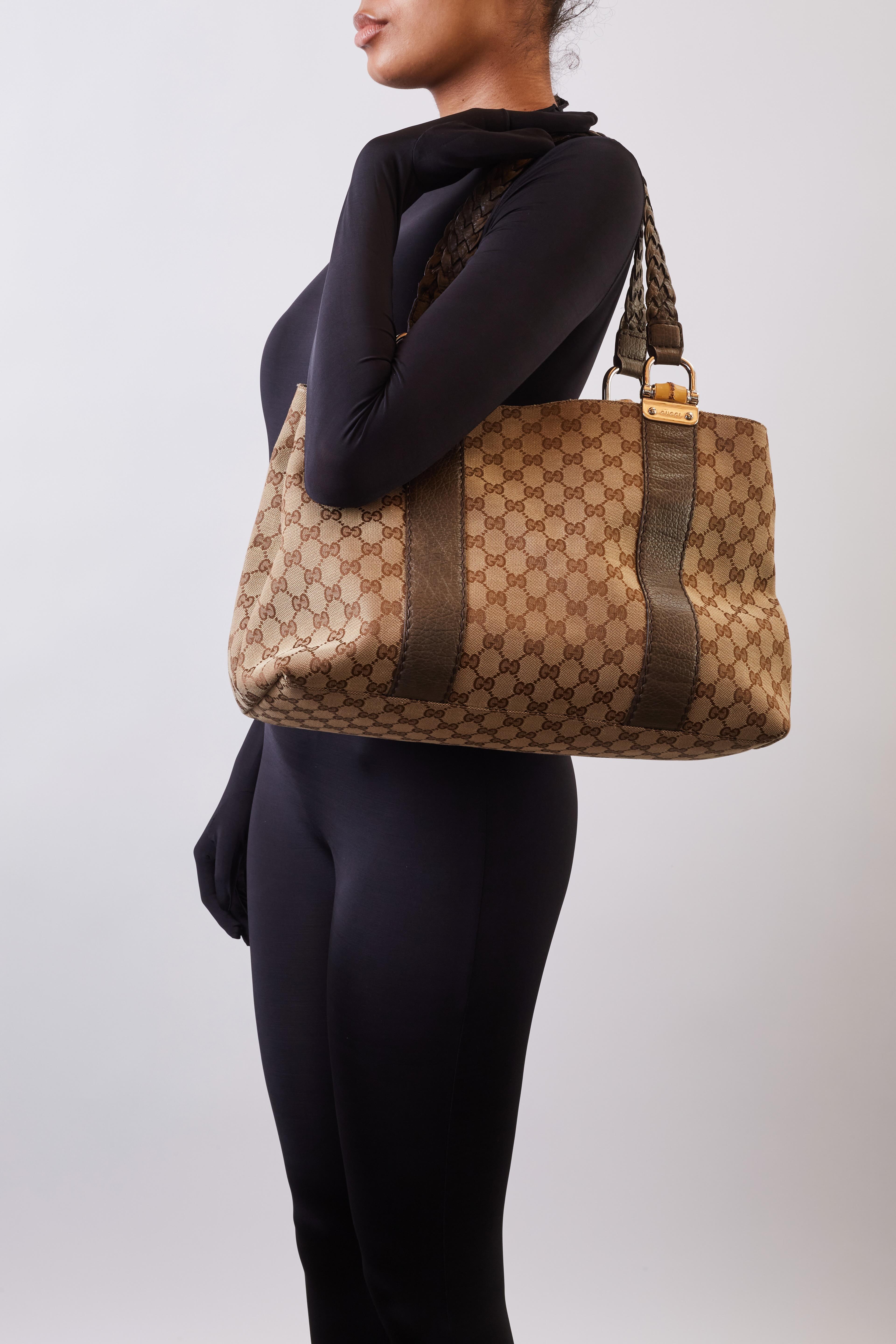 This tote bag is made of Gucci GG monogram canvas with complimentary olive green leather finishes. The bag features dual braided leather strap top handles, silver links with a bamboo rod embellishment at strap attachment and leather details down the