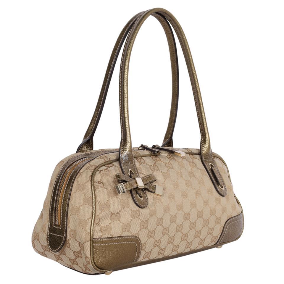 Authentique sac à bandoulière Princy Boston à monogramme marron et or de Gucci. Le sac à bandoulière Princy présente un corps en toile avec des garnitures en cuir doré, des bretelles en cuir roulées, une fermeture à glissière sur le dessus et une