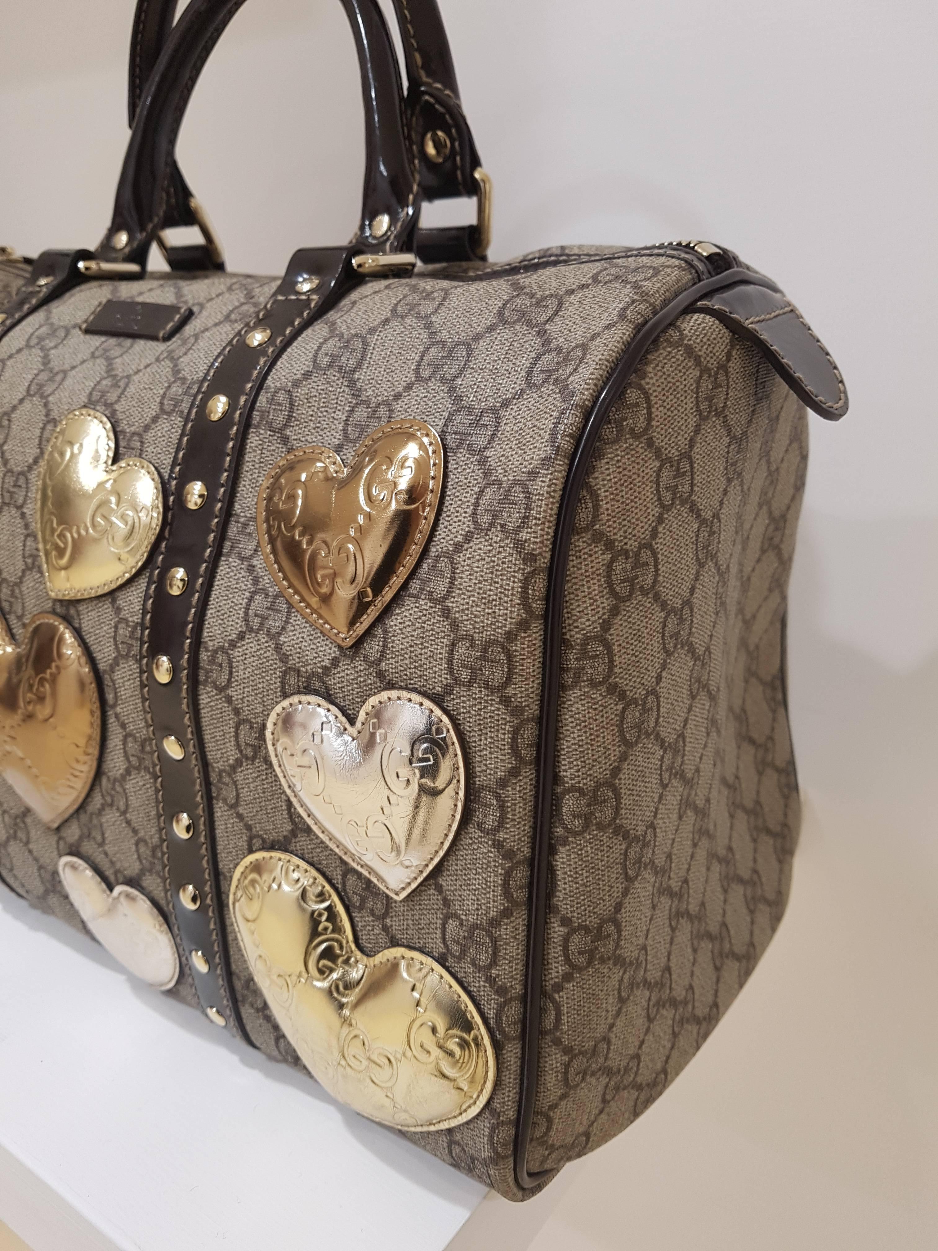 Gucci GG Monogram Silver Gold Heart tote bag

brown leather gg fabric tote bag with gold tone studs on both sides
gold and silver heart on the front