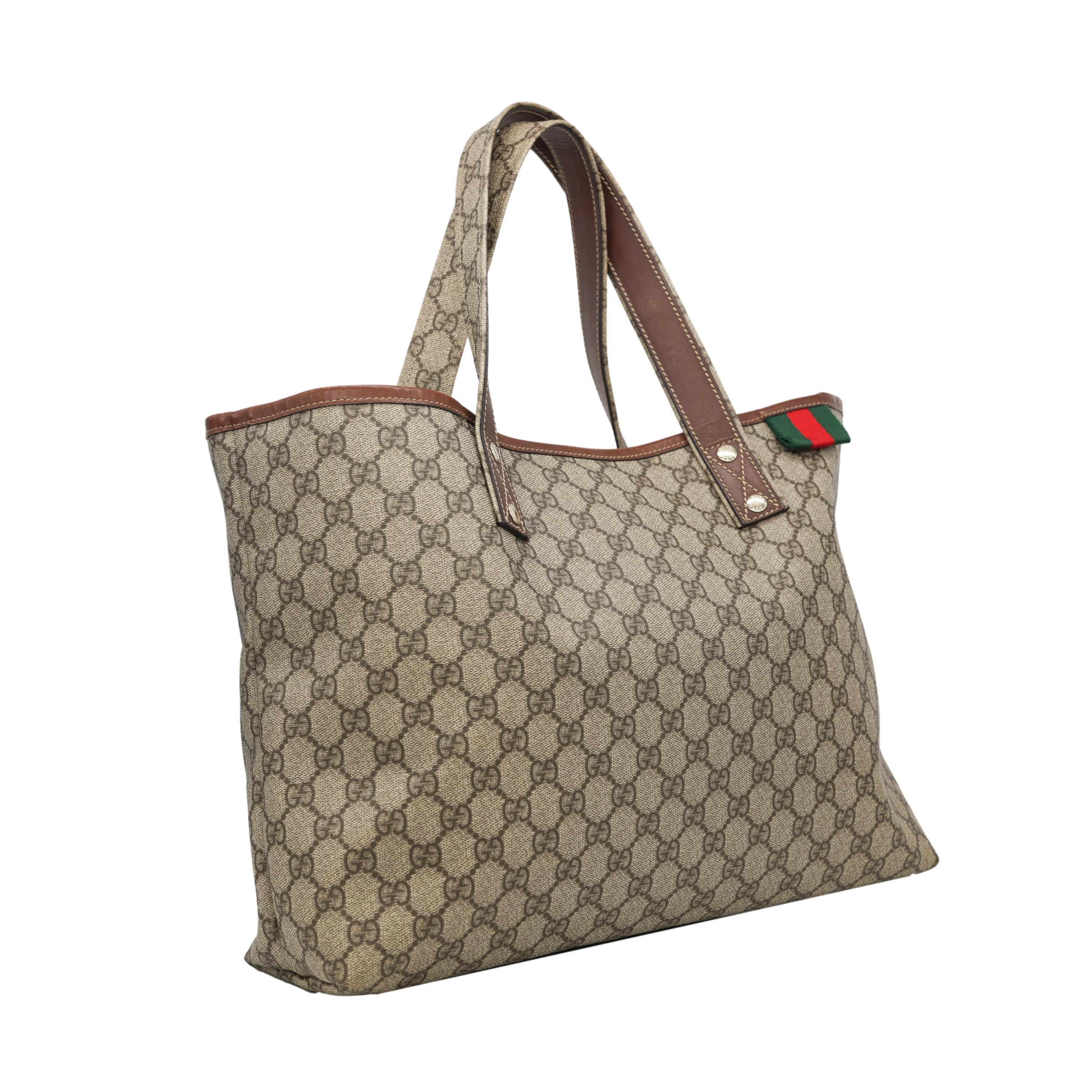 Gucci GG Monogram Supreme Brown Canvas Medium Shelly Tote Bag. This classic Gucci Tote 