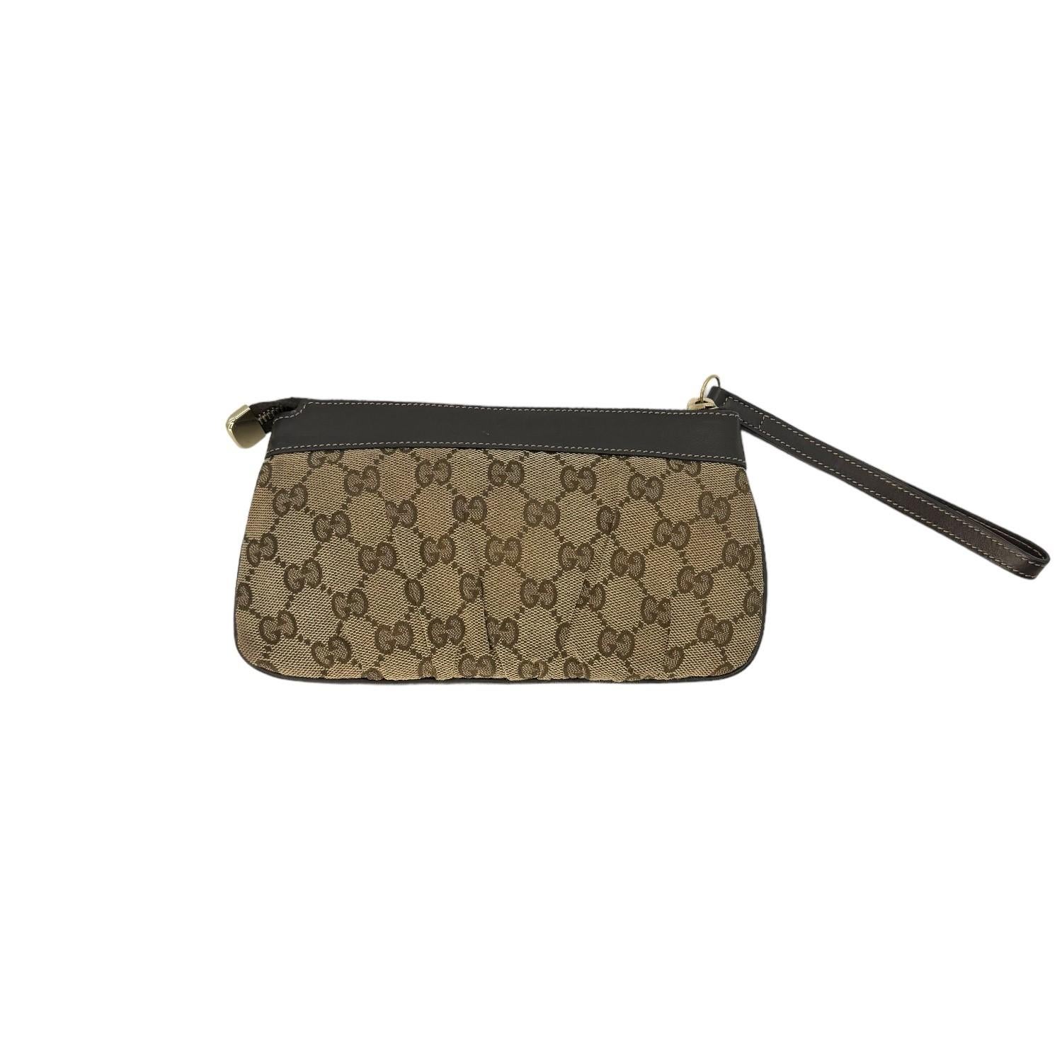 This Gucci Zip Pouch is finely crafted of the classic Gucci GG Monogram canvas exterior with leather trimming and gold-tone hardware. It has a zipper closure that opens up to a brown nylon and leather interior with multiple card slots. This Gucci