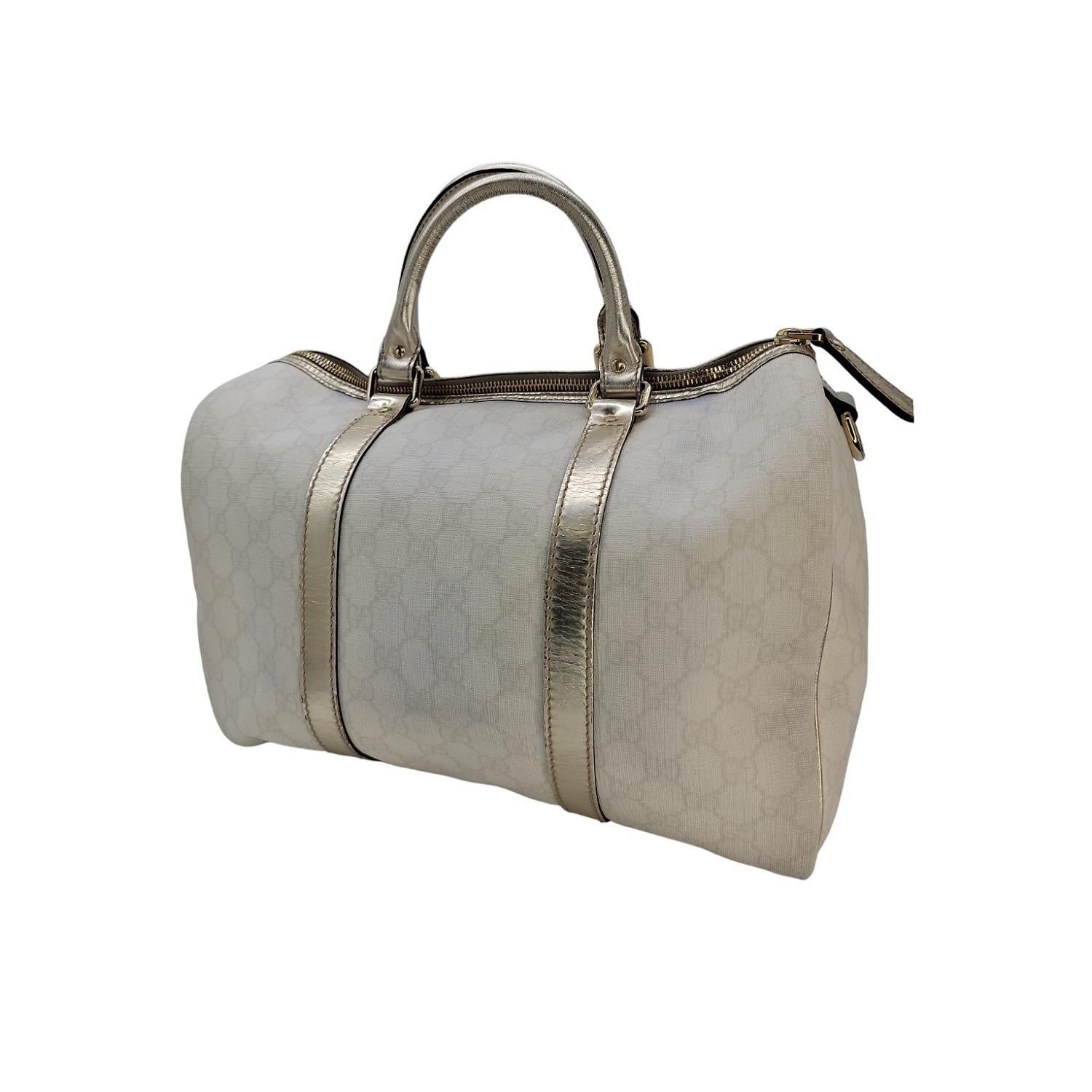 This chic medium Boston style tote is crafted of Gucci GG monogram canvas. The bag features gold metallic leather top handles with polished light gold hardware. The top zipper opens to a spacious black fabric interior with a patch pocket. This
