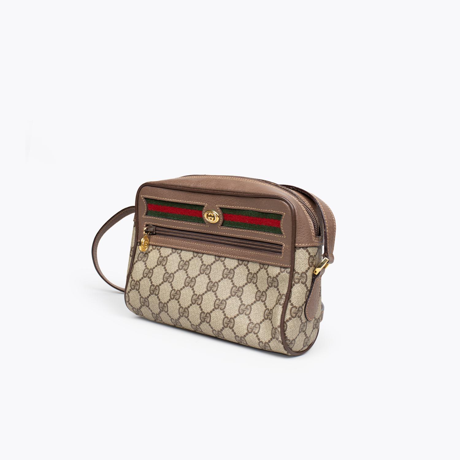 Brown and tan coated canvas Gucci GG Plus Ophidia crossbody bag with

– Gold-tone hardware
– Brown leather trim
– Single flat shoulder strap
– Woven web trim, single flat shoulder strap, zip pocket at front, tan coated lining, zip pocket at interior
