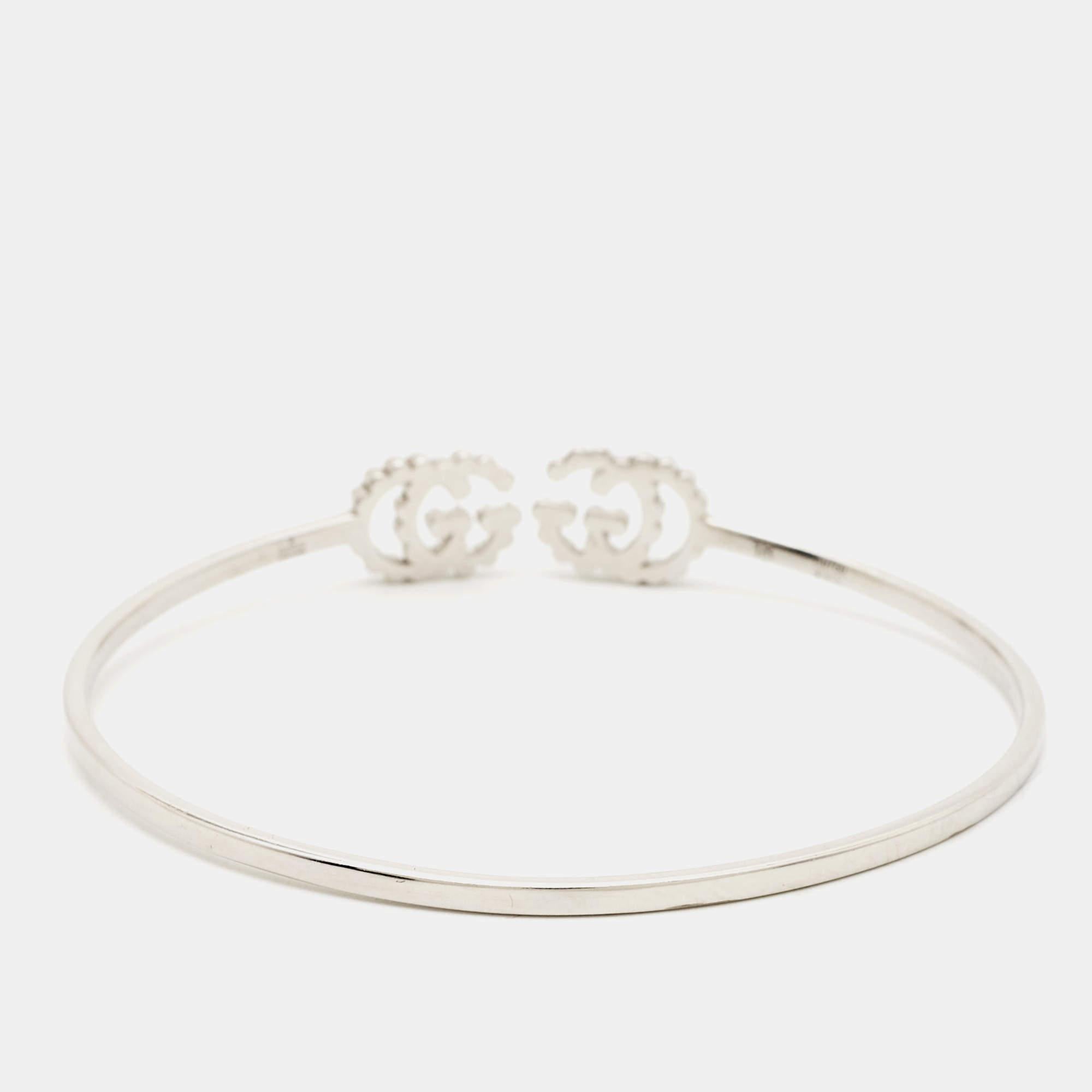 To form this GG Running bracelet, Gucci brings to light the Double G motif—a much-loved code inspired by a House design dating back to the '70s-a hallmark era. Sculpted using 18k white gold, the open cuff bracelet has a thin, wire-like band