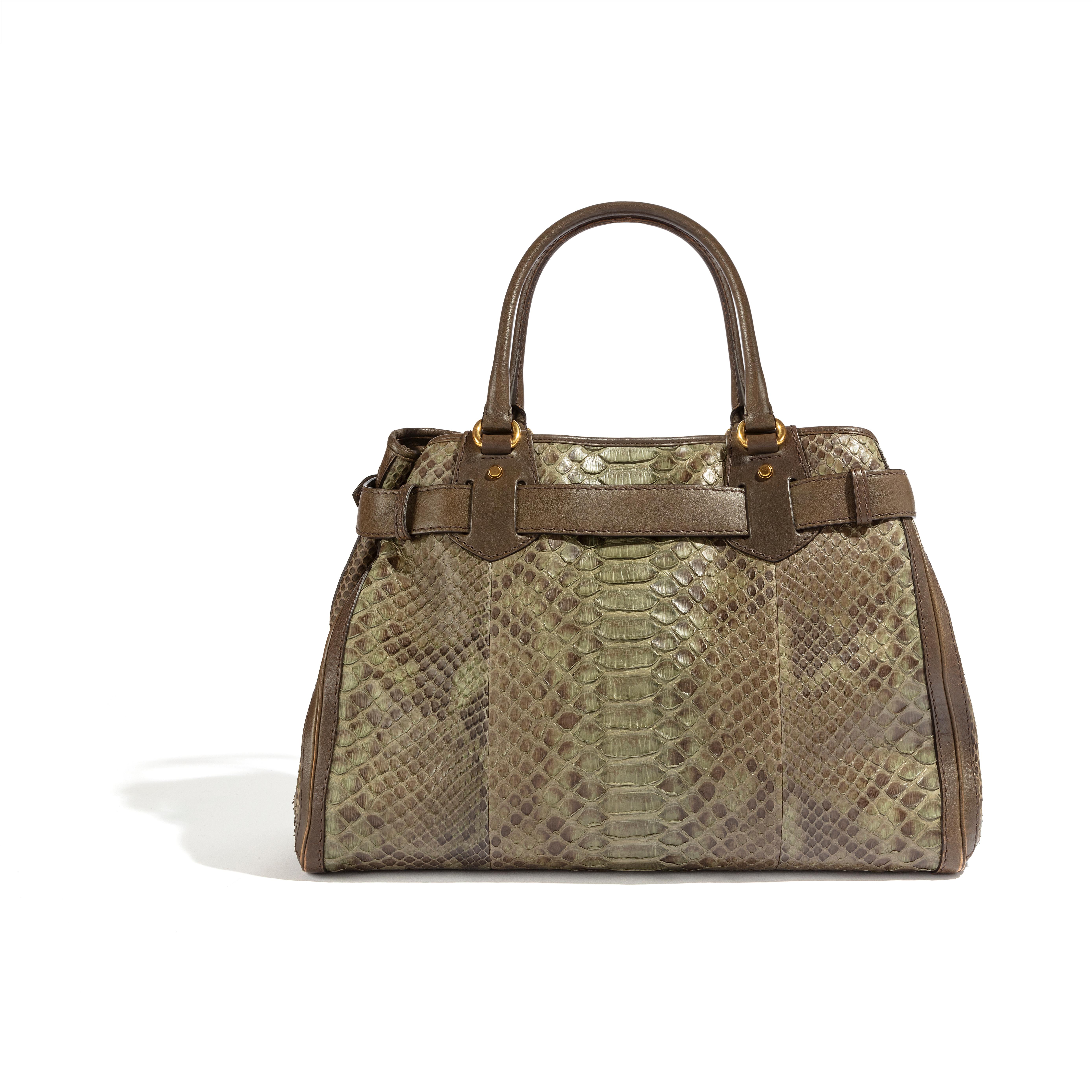 The GG Running Handbag, expertly crafted by Gucci, offers a luxurious and unique accessory to elevate any outfit. Designed with exotic leather, this handbag boasts a distinctive appearance. While the markings on the inside may differ and there may