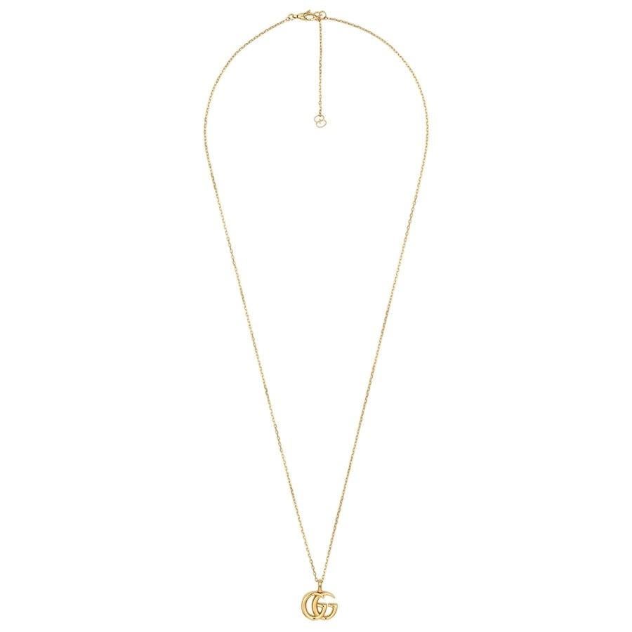 A small gold pendant necklace is a wardrobe essential for women. For your consideration: this 18K yellow gold piece with double G motif from Gucci's GG Running collection. Dress the simple and understated piece up or dress it down; the versatile